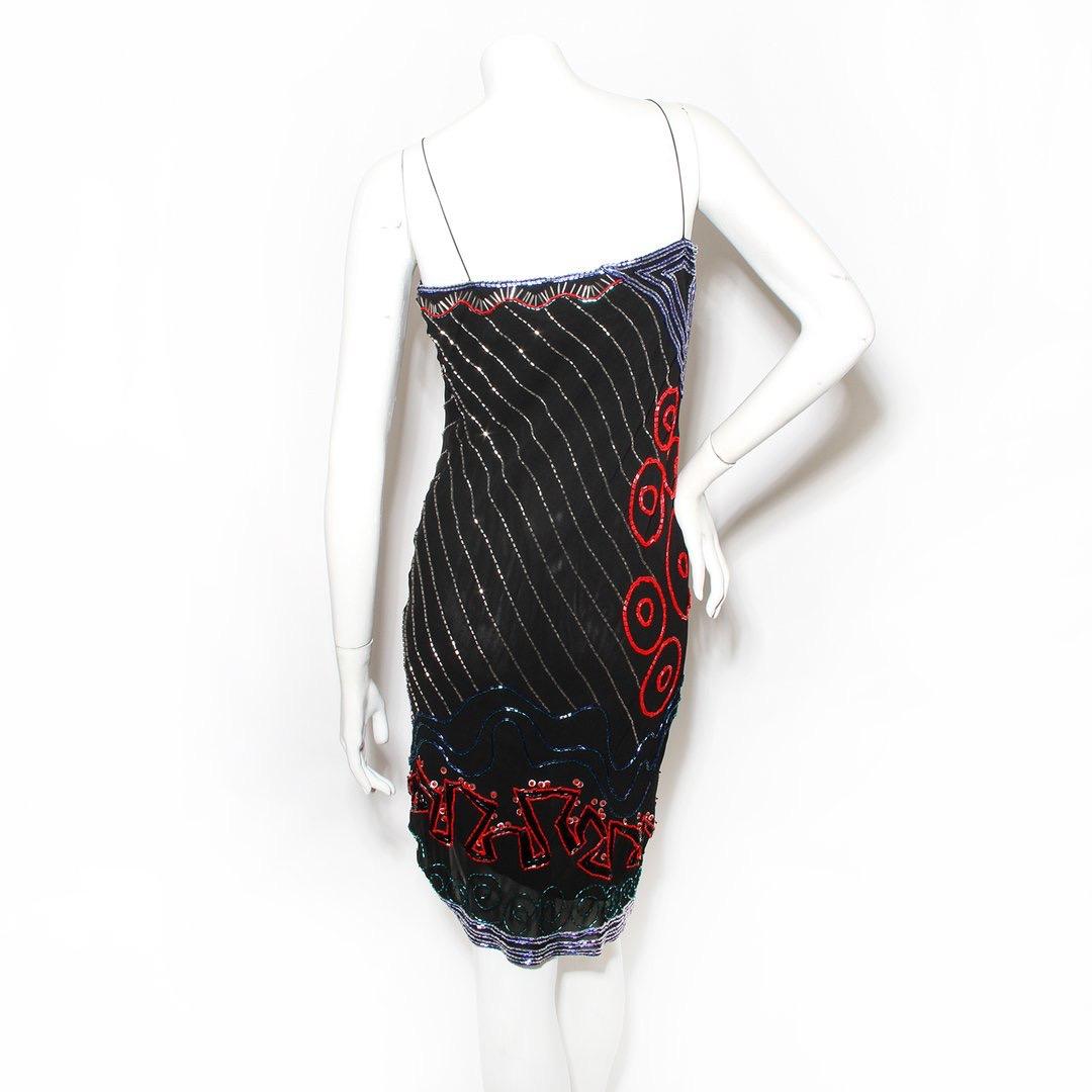 Vintage beaded slip dress by Fabrice
Black 
Red, blue, and pearl beaded geometric patterns
Sleeveless
Spaghetti strap
V-neck cut
Asymmetrical hem
Slip-on
Asymmetrical hem 
Made in New York
Condition: Great vintage condition, a few loose beads in