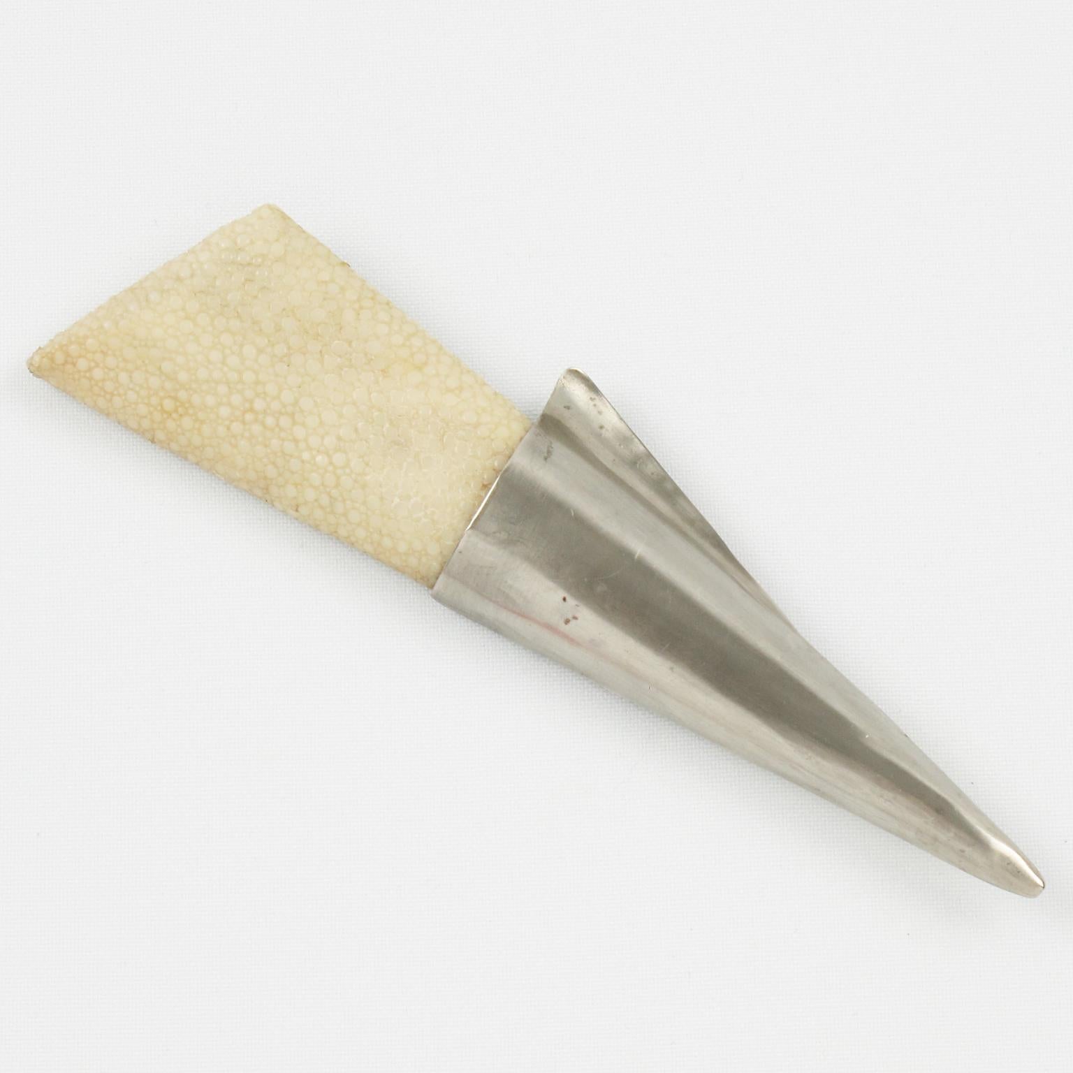 This is a fancy Fabrice Paris pin brooch. This Art-Deco-inspired piece features an oversized elongated dimensional shape with silvered metal in a brushed finish aspect and natural shagreen (stingray skin) in off-white color. The piece has a security