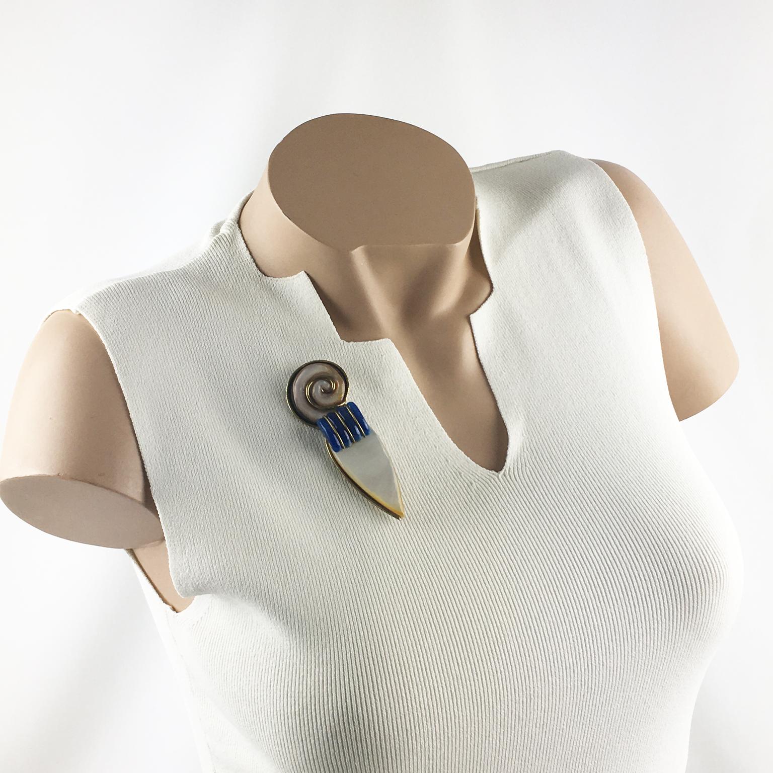 Adorable Fabrice Paris signed pin brooch. Dimensional geometric piece with Art-Deco-inspired feeling. Gilded brass framing, topped with real mother of pearl and blue lapis lazuli glass cabochons. The mix and match of material are really typical of