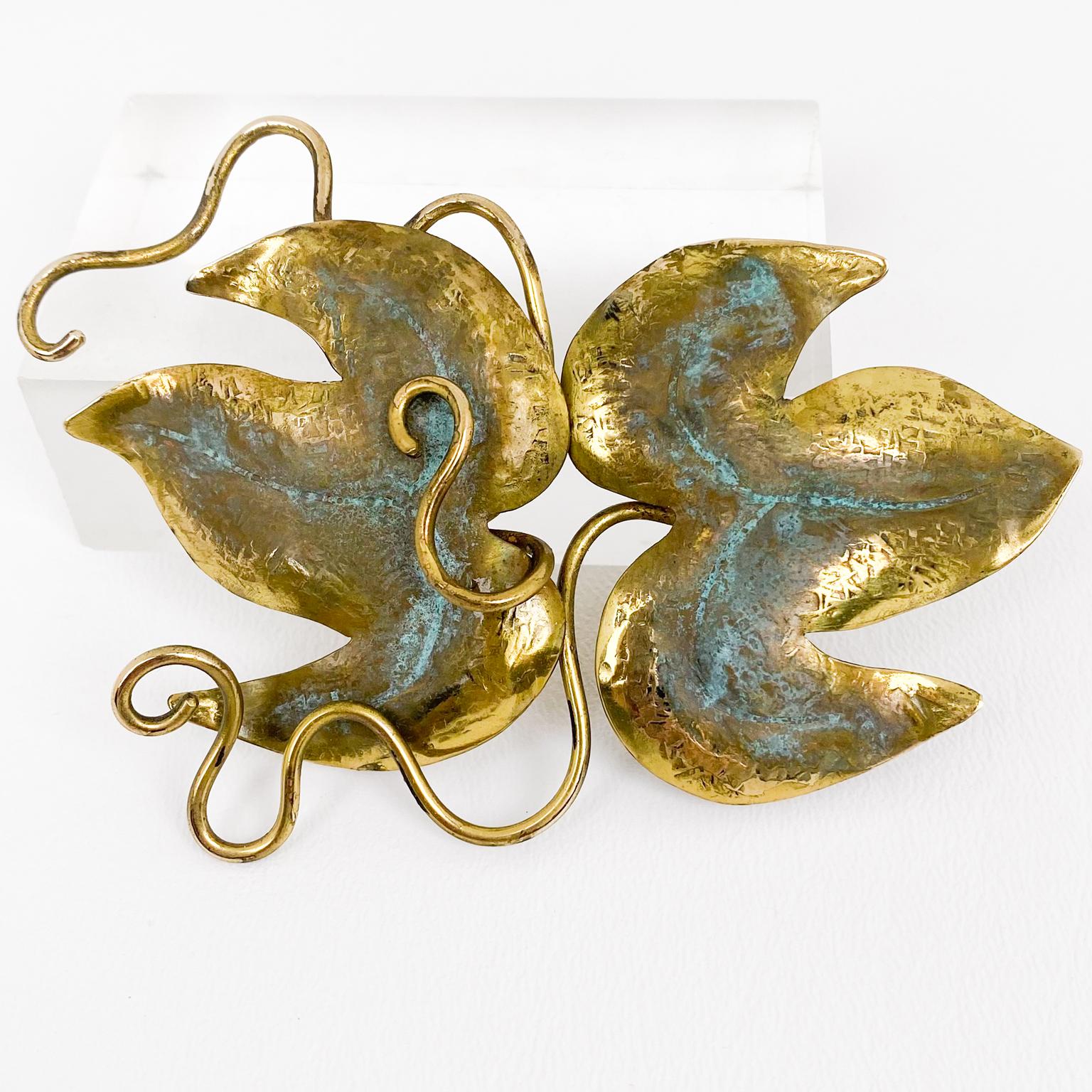 Fabrice, Paris designed this beautiful, organic-inspired floral pin brooch. It features a massive brass vine leaf and branch design with dimensional hand-raised, carved detailing and a verdigris patina. The pin has a security-closing clasp and is