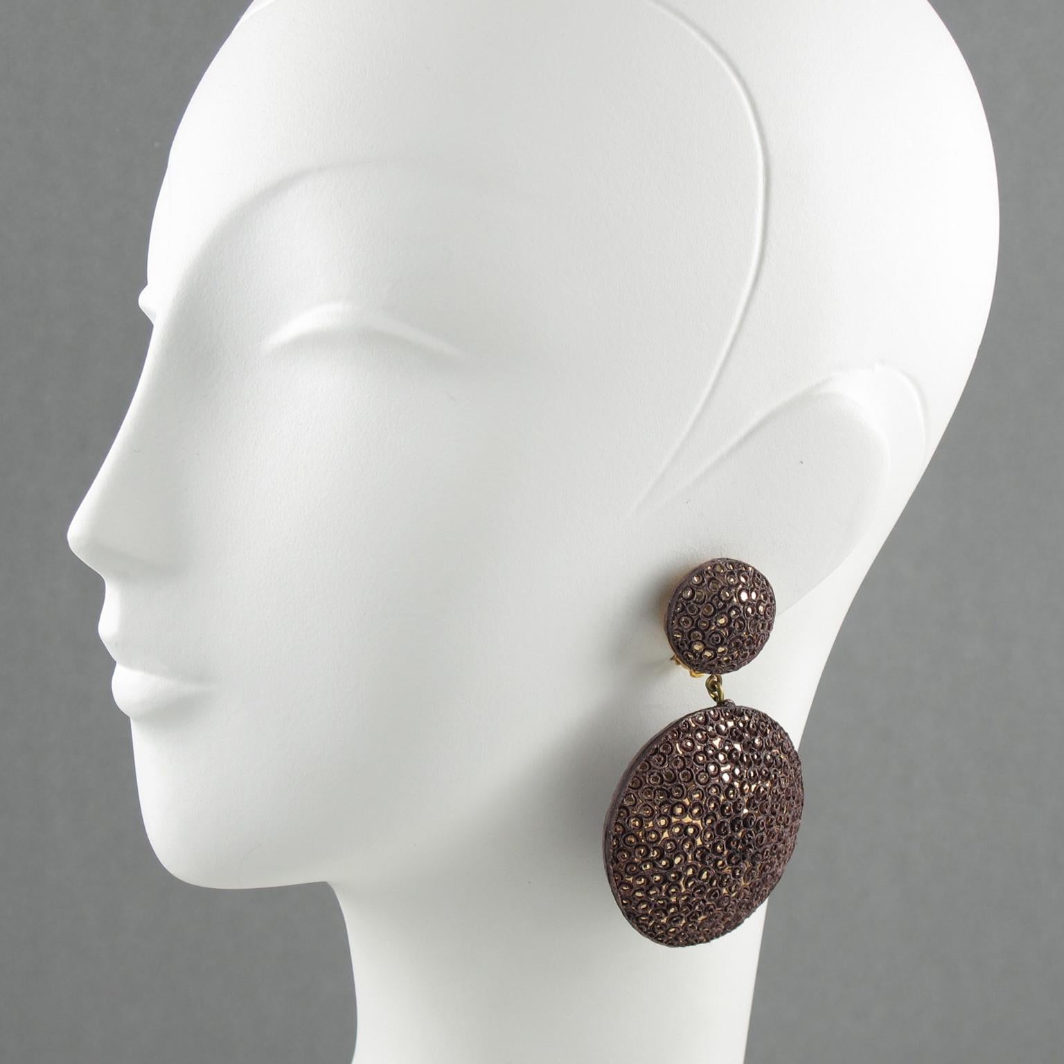 Lovely resin clip-on earrings by Fabrice, Paris. Completely handmade, each piece is unique. Oversized dangling dimensional geometric hand raised shape with detailing in hickory taupe color with textured pattern imitating shagreen. Signed at the