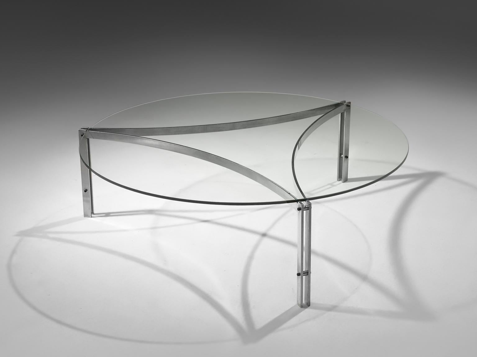 Round coffee table in glass and stainless steel, Denmark, 1970s. 

This modern, elegant coffee table stands out for its simplicity. Exposing it's refined yet strong frame, this piece is beautifully balanced in its graphic design. 
Designed in the
