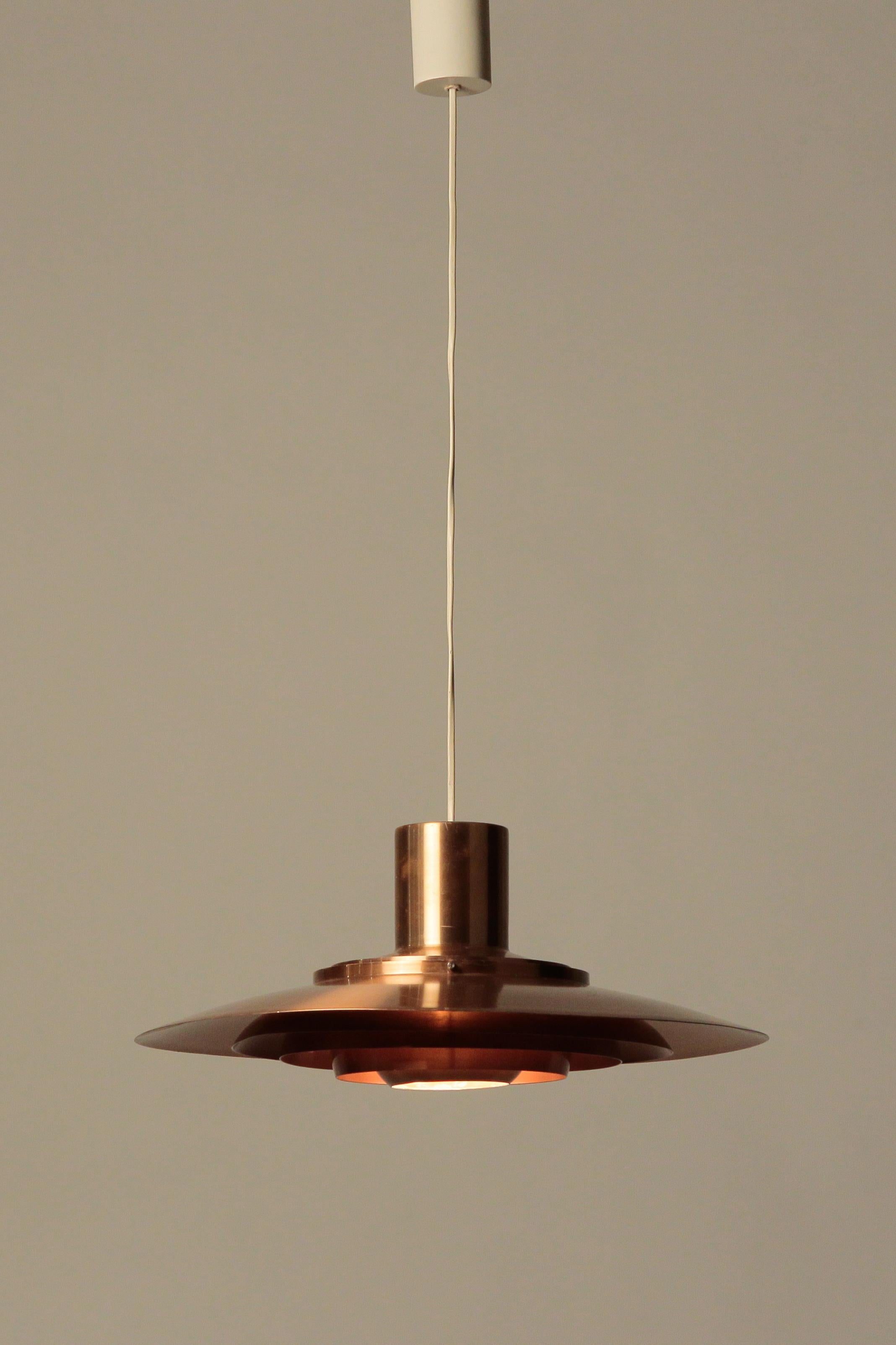 Medium Fabricius & Kastholm ceiling lamp, copper. Design 1964, manufactured by Nordisk Solar in Denmark. Gives off a very warm light.