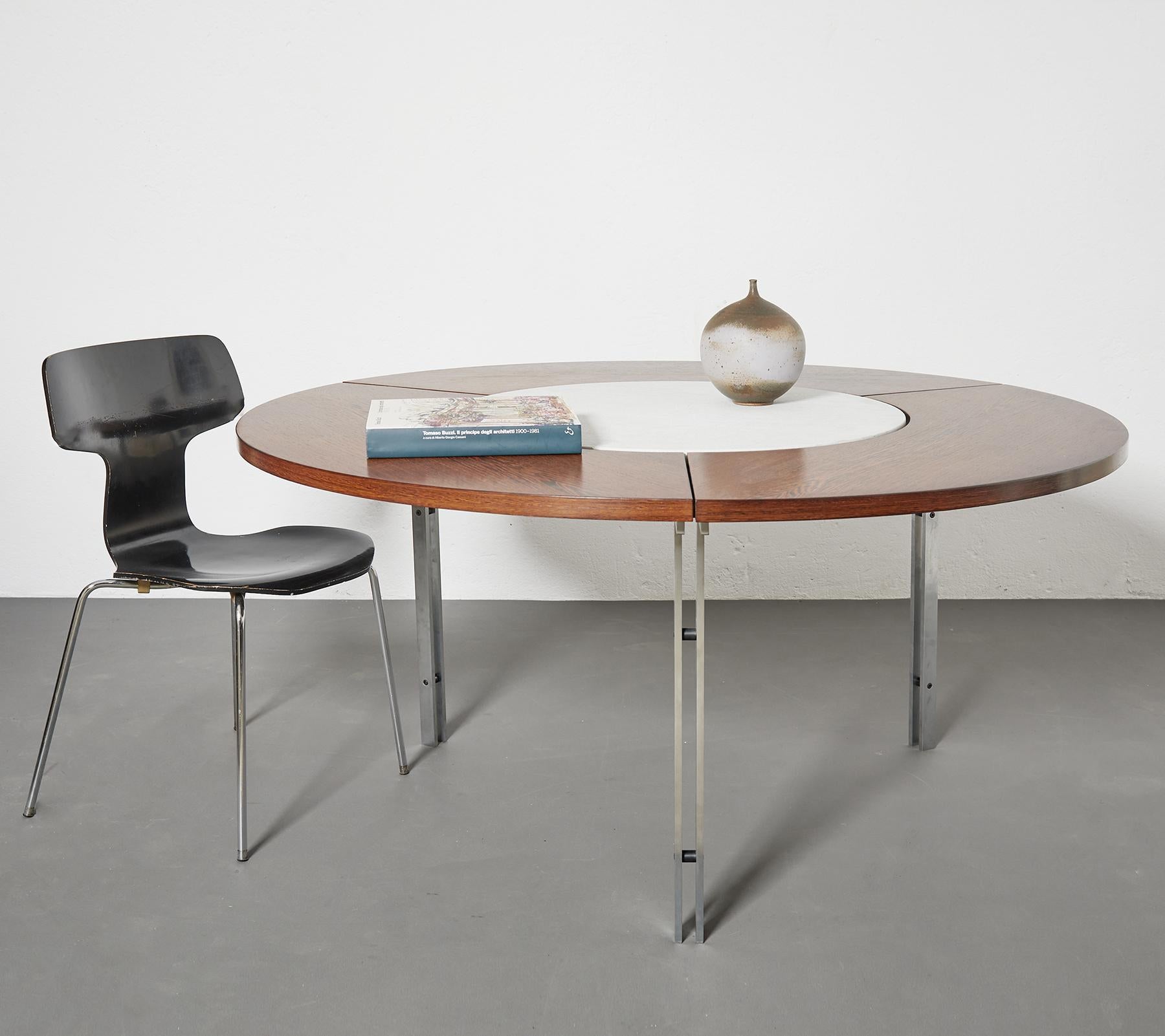 Fabricius & Kastholm dining or conference table by Alfred Kill, Germany 1965

The structure is in brushed matte steel which can be entirely disassembled. 

The table top in wenge wood is composed of three parts and boasts a circular white