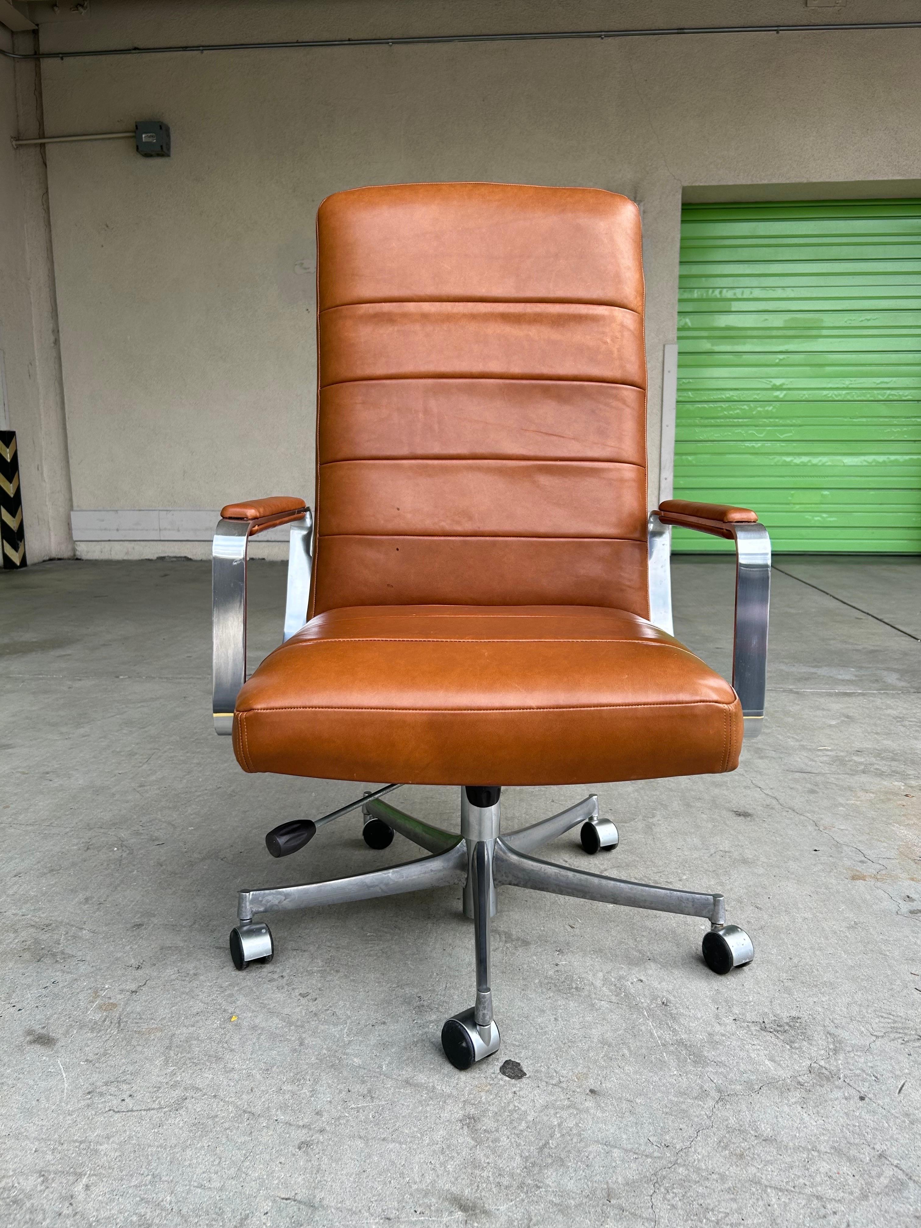 Elegant modernist design.
Wood construction with leather and chrome plated steel armrest with brushed aluminum base and plastic castors.
(The up + down hardware under the seat appears to not work and needs to be tweaked a bit or left as is. It does