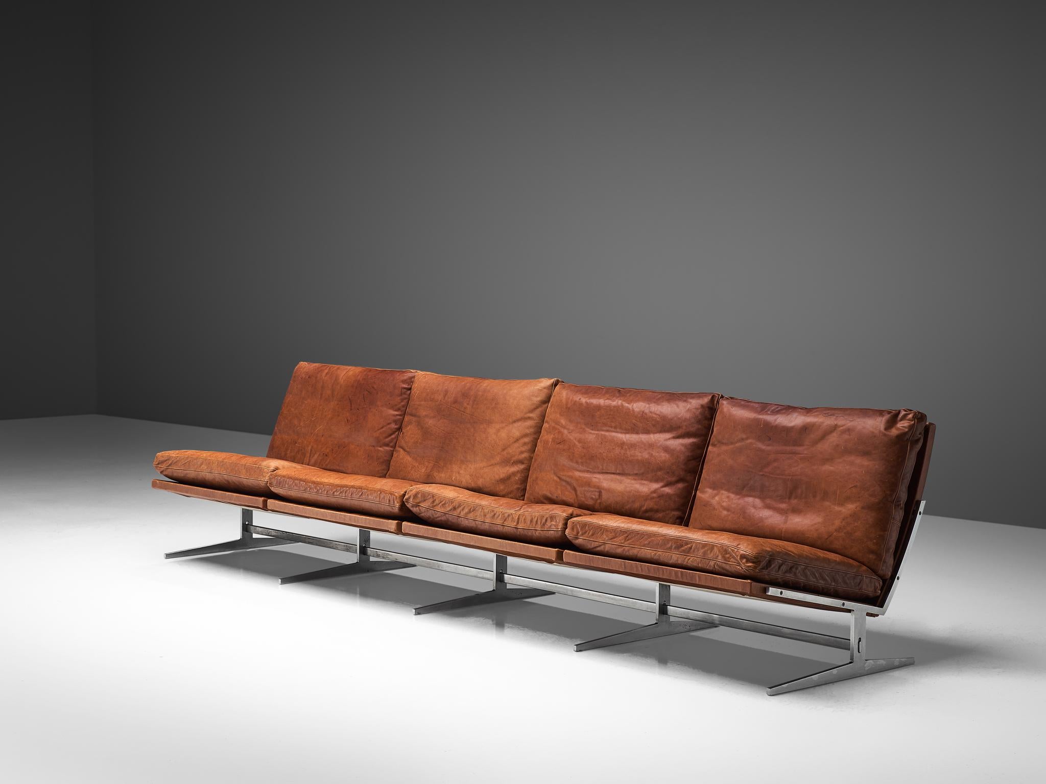 Preben Fabricius & Jørgen Kastholm, sofa model BO561, brushed steel and cognac leather, Denmark, 1962. 

This modern slipper sofa is made out of steel and leather. Besides this slick and Minimalist design, the midcentury sofa is suprisingly
