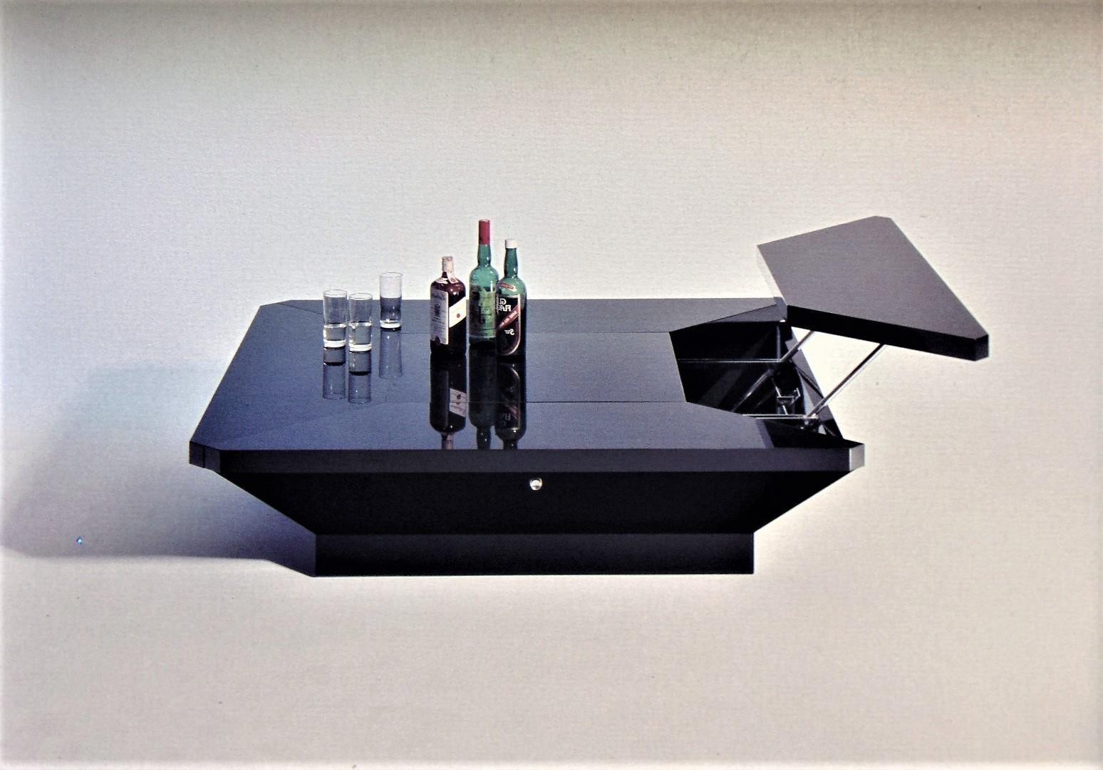 This geometric form table features four adjustable surfaces (petals) that rise via mechanized steel rods for dining height use, single buttons on each side are used to release the platform so that it can rise to its full height. Beautiful black