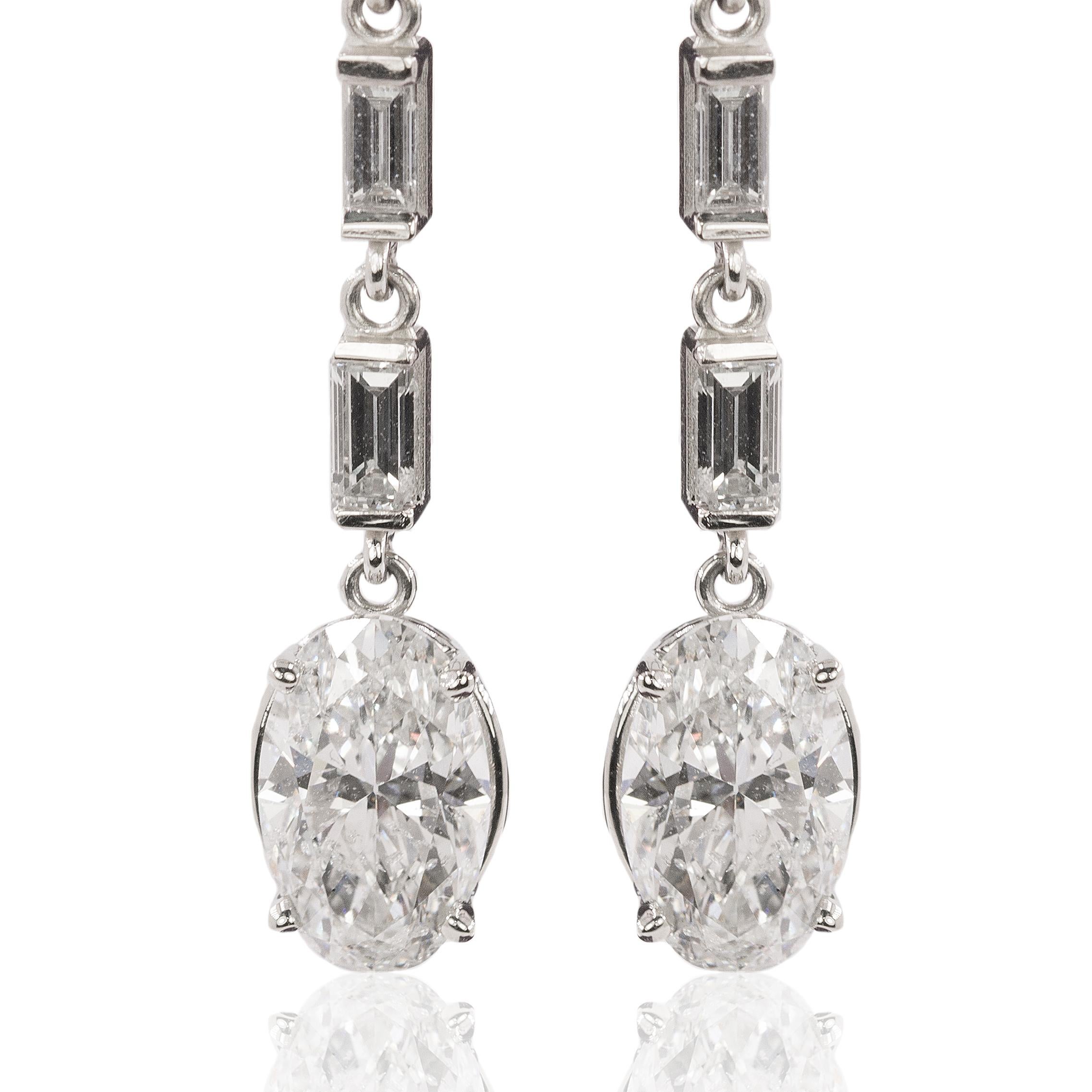 18k White gold earrings with 2 Oval Brilliant diamonds weidhing 2.82 carats and 2 pear shape diamonds weighing 1.21 and 6 straight baguete cut diamonds weighing 0.80 carats. 