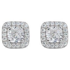 Fabulous 18k White Gold Earrings features a dazzling 1.41 carat cushion shape na