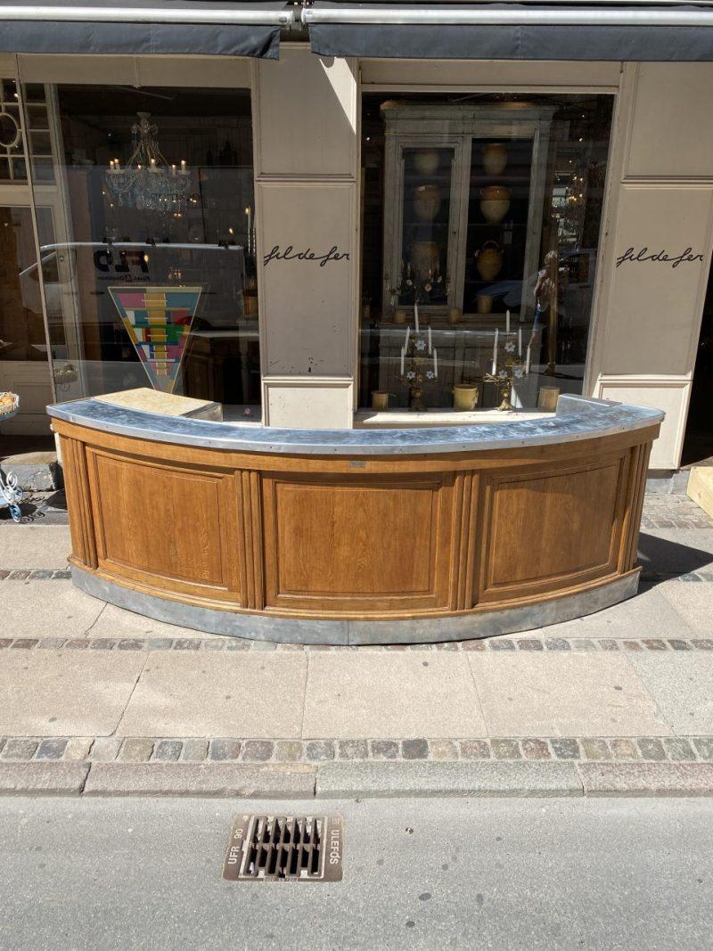Authentic, stunning, and utterly charming old oak bar counter from France circa 1940. It is crescent shaped, with the manufacturer’s mark on the front of the bar. Originates from Paris, where it was a fixture in a hotel bar.

This marvellous piece