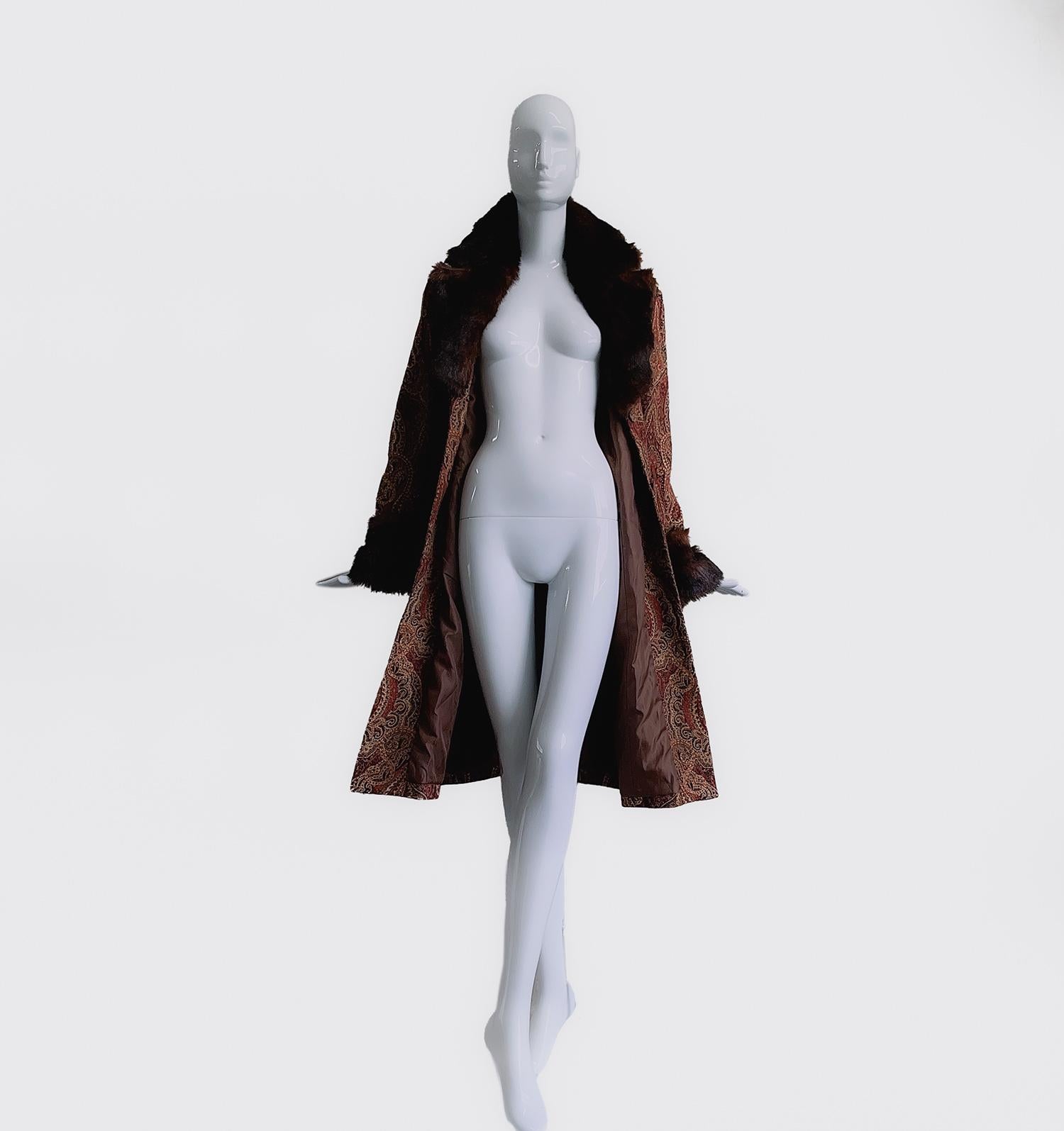 
Dies ist ein atemberaubender Mantel aus den späten 1970er Jahren mit weichem Kunstpelzkragen und Manschetten und schönem verzierten Stoff.
Der Schnitt und die Form scheinen von den Flapper-Mänteln der 1920er Jahre inspiriert zu sein, und die großen