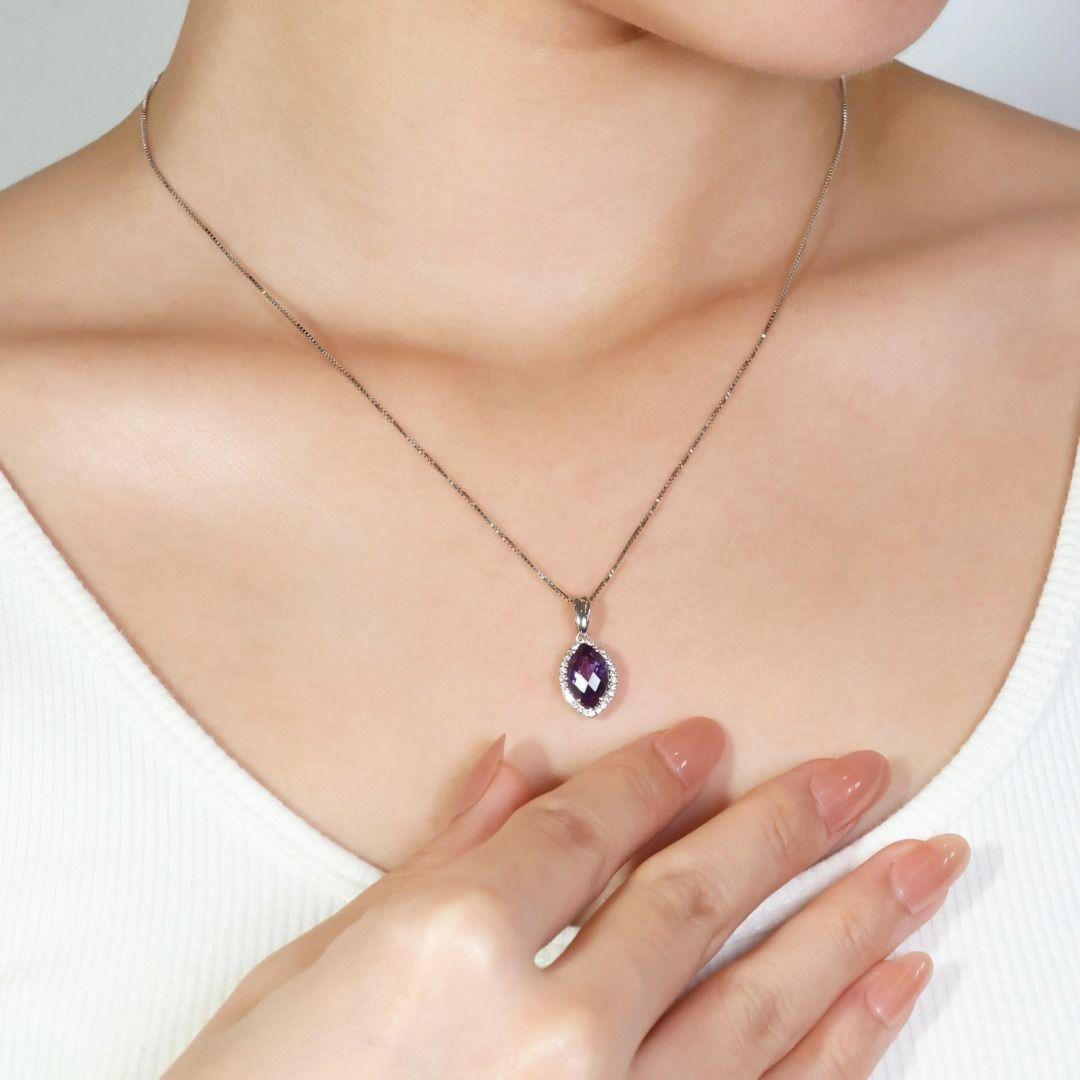 Featuring this stunning 18k white gold necklace with a mesmerizing 4.03ct marquise-cut diamond in a captivating shade of purple. The center stone is accentuated by 28 sparkling round brilliant diamonds totaling 0.14ct, boasting a crisp H color and