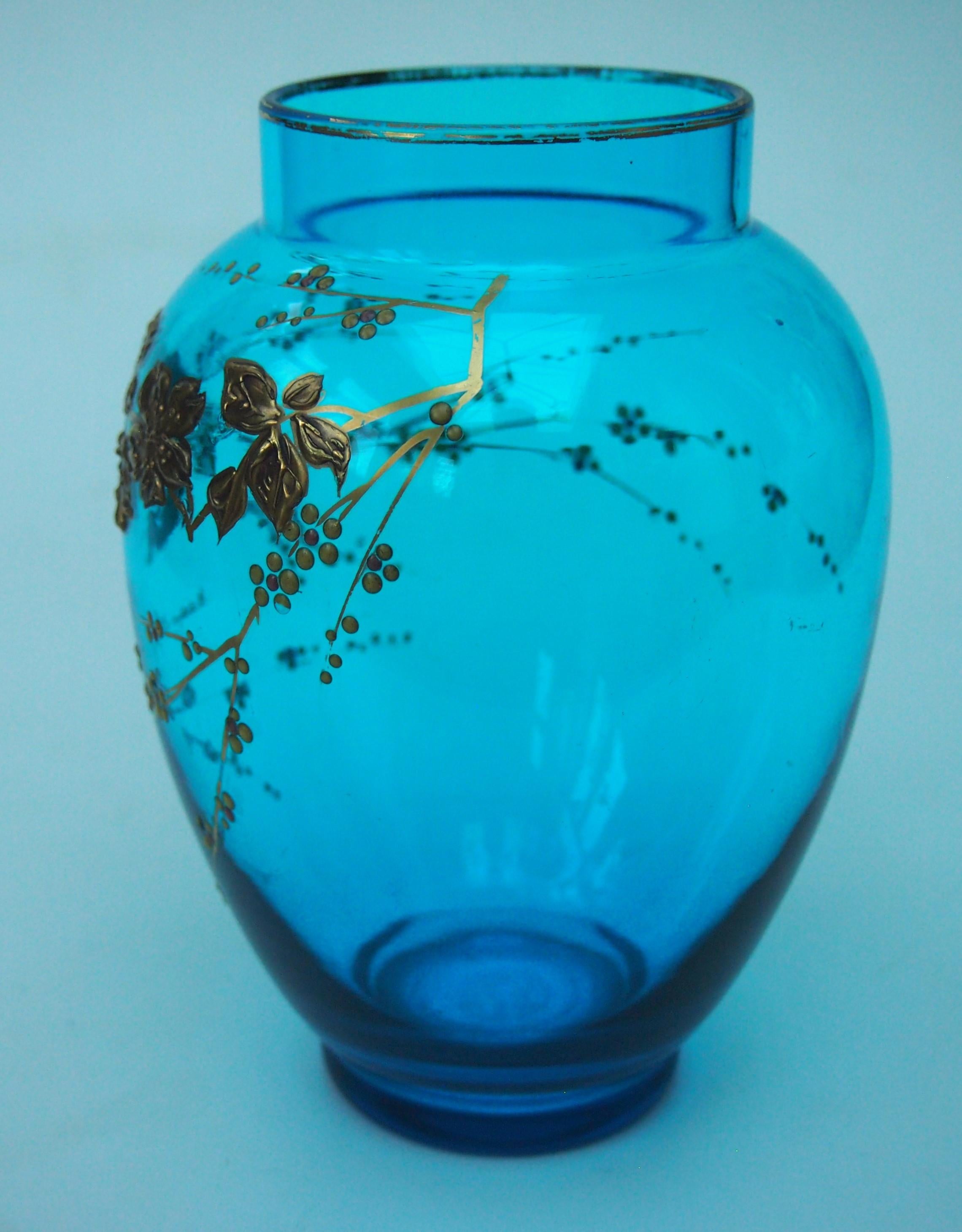A fabulous Aesthetic Movement bright blue and deeply gilded Baccarat Crystal vase. This bright blue was one of their signature colours -it is also  deeply gilded in the Baccarat raised gilding technique, showing blooming branches of a prunus like