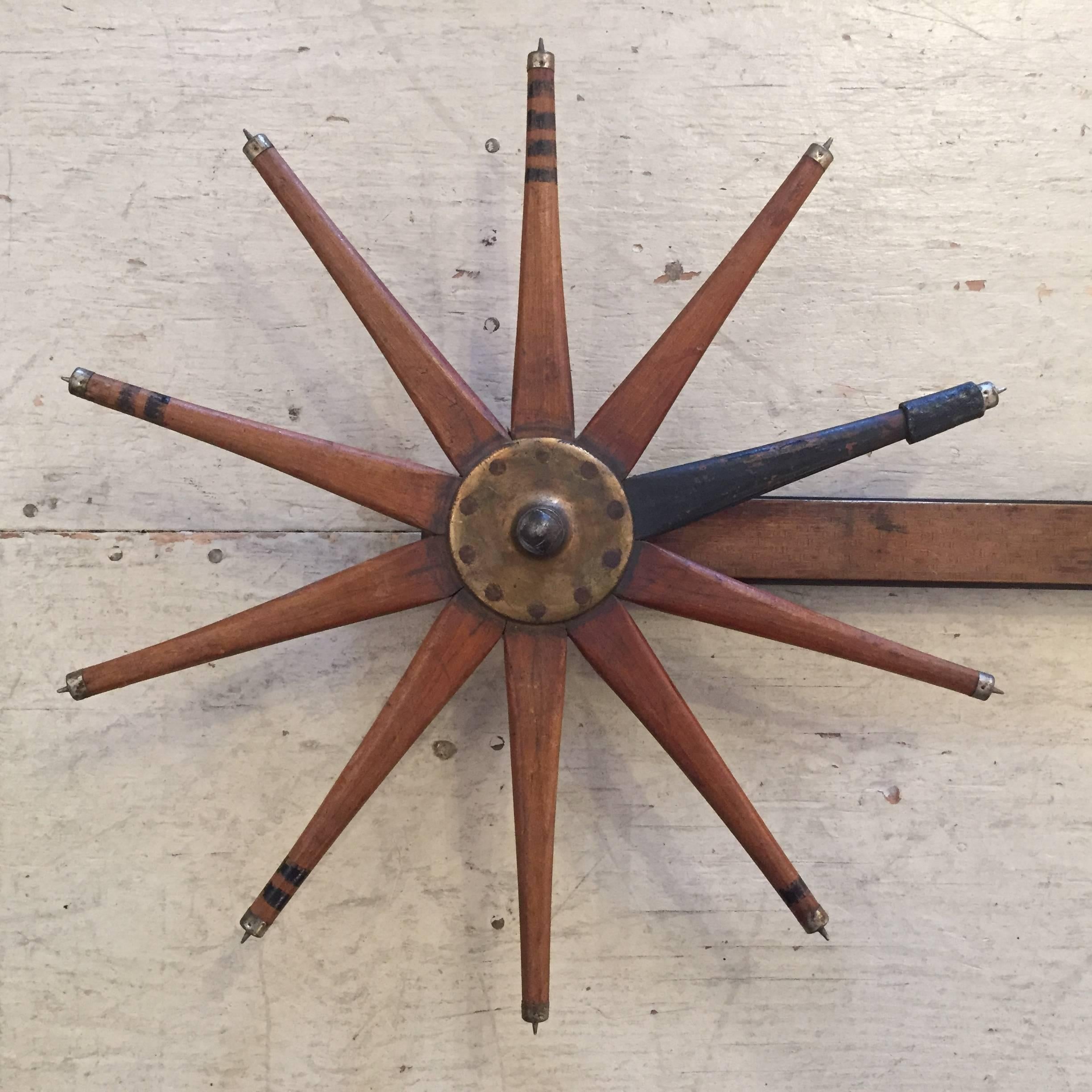 A rich in character 19th century measuring instrument used on trees, wonderful as a wall-mounted sculpture for it's rustic yet beautiful combination of wooden shapes including a wheel reminiscent of a carnival toy and a caliper with original