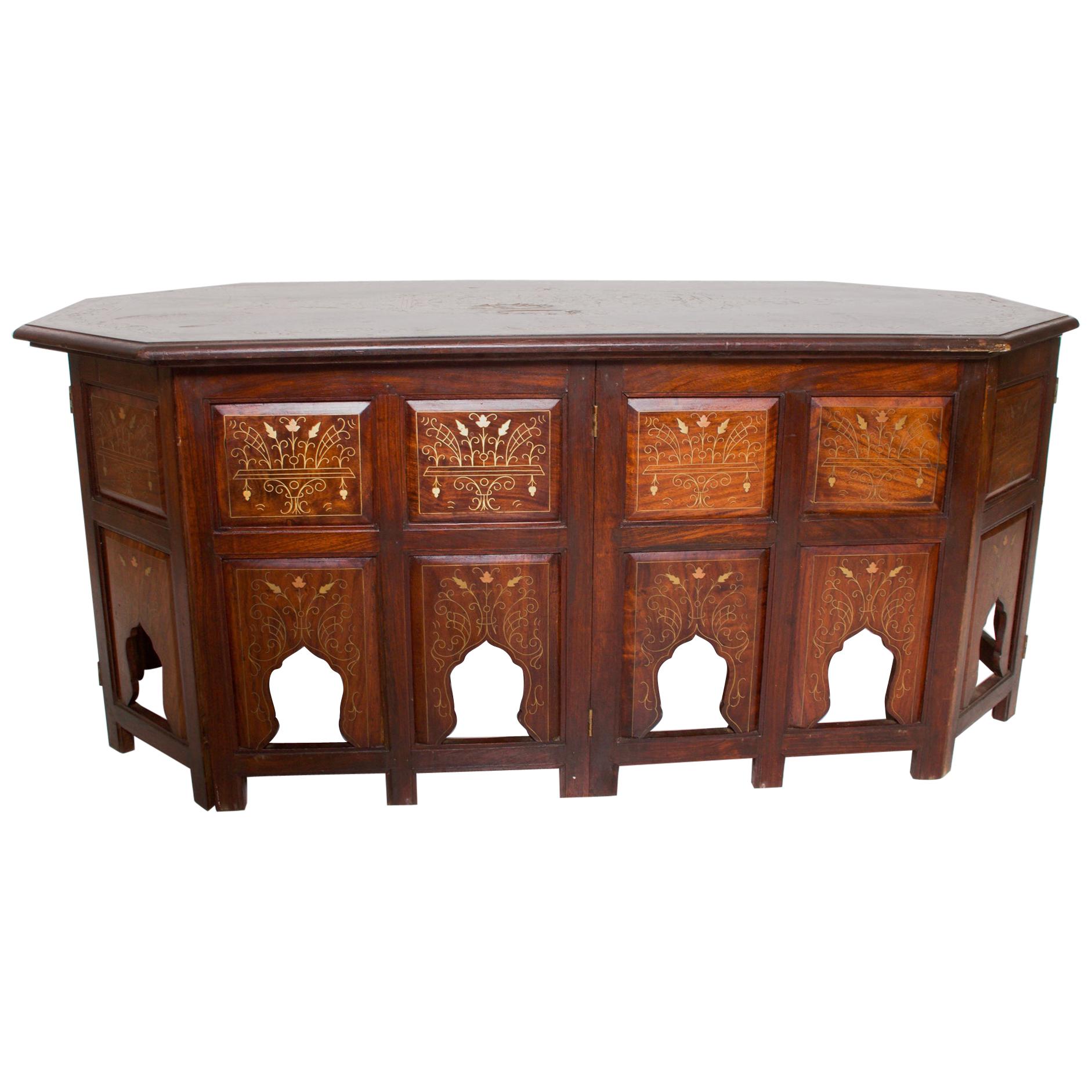 Coffee Table
Anglo-Indian Rosewood Coffee Table Bone Inlay elongated octagonal shape.
Intricate carved bone folding collapsible concertina base. Graceful design with architectural arches.
Dimensions: 48W x 23.5D x 21 H
Original Unrestored Vintage