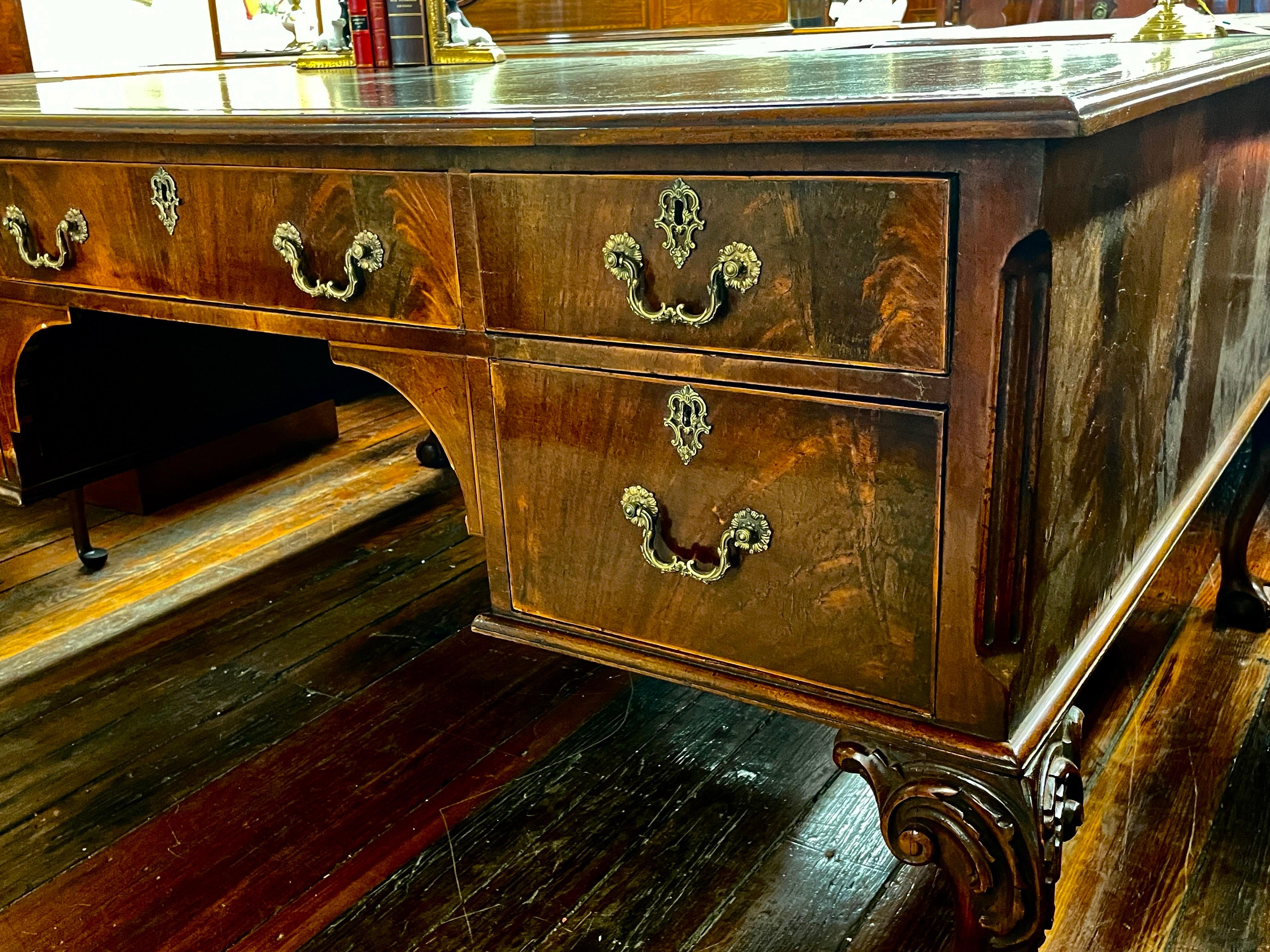 This is an extraordinary Old/Antique English highly figured flame or crotch mahogany Chippendale Style Very Large Desk.  It may be used as a partner's desk, but the back side is finished and has faux (non-working) drawers.  Its size still would