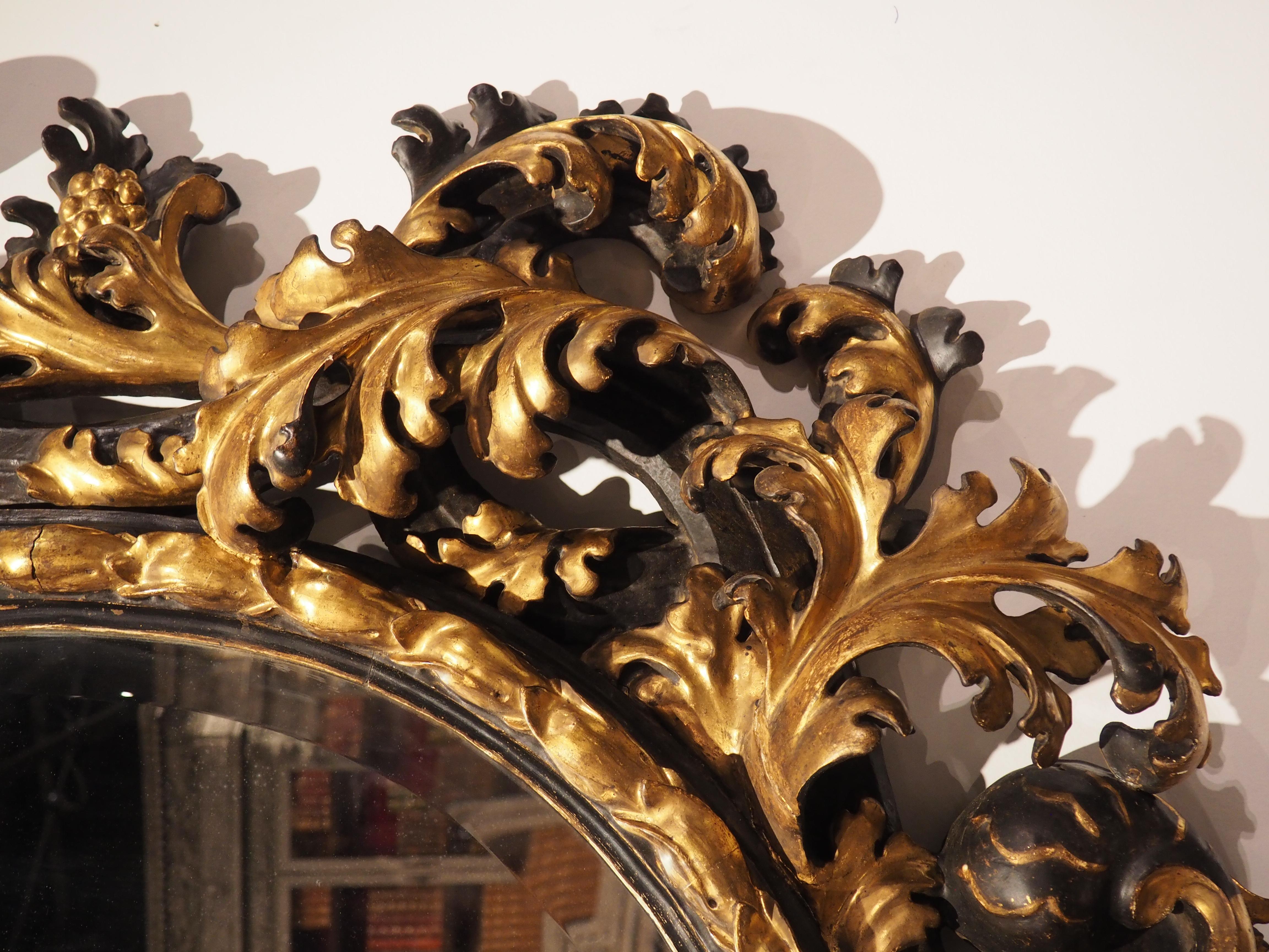 Hand-Carved Fabulous Antique Florentine Black and Gold Wall Mirror, Circa 1850 For Sale