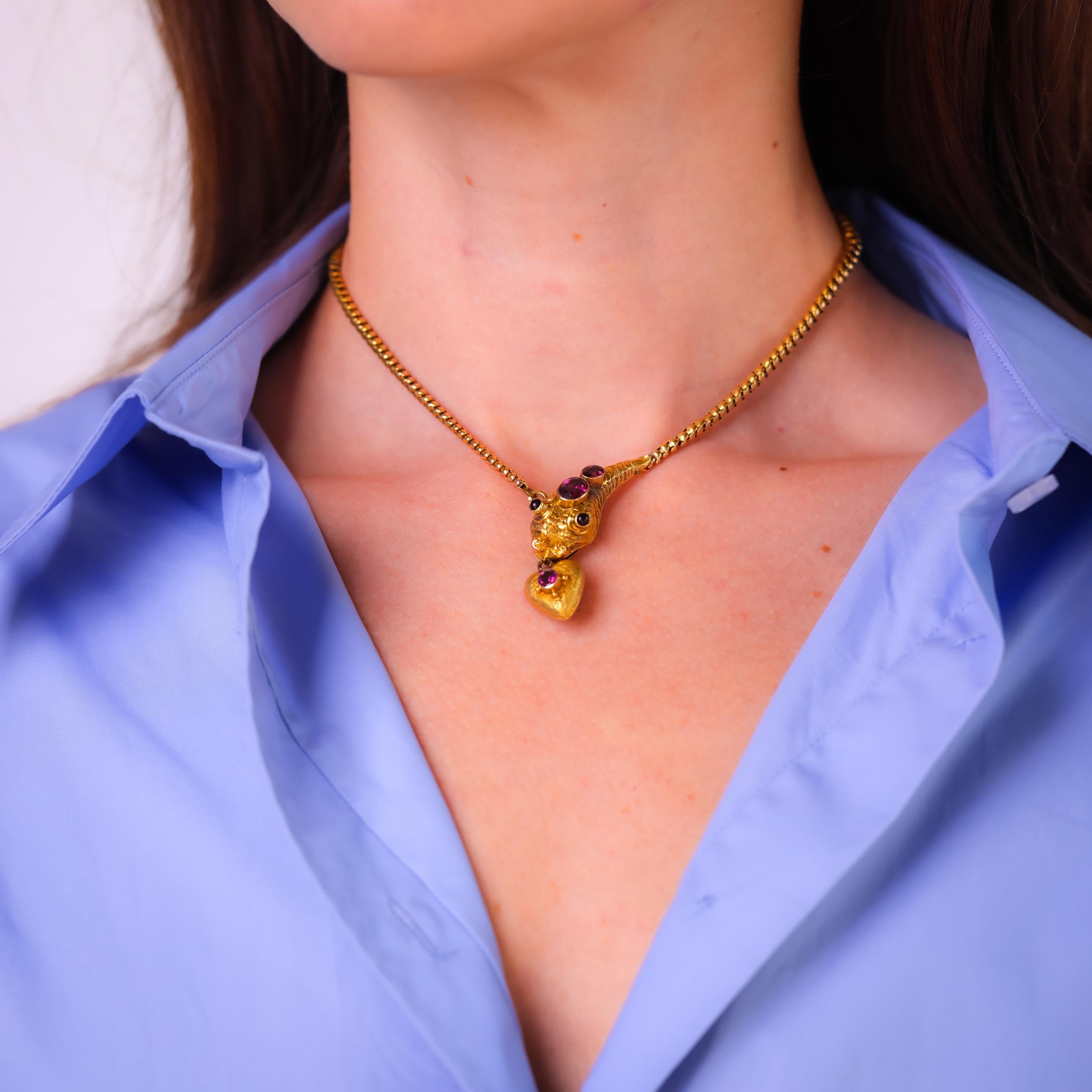 Center stone: 2 oval cut, 2 cabochon cut, and 1 round cut garnets
Total garnet weight: Approximately 1.70 carats
Metal: 14k yellow gold
Era: Antique
Circa: 1840's
Hallmarks: Shell purity mark and makers marks
Size: 15.5 inches in length
Gram weight: