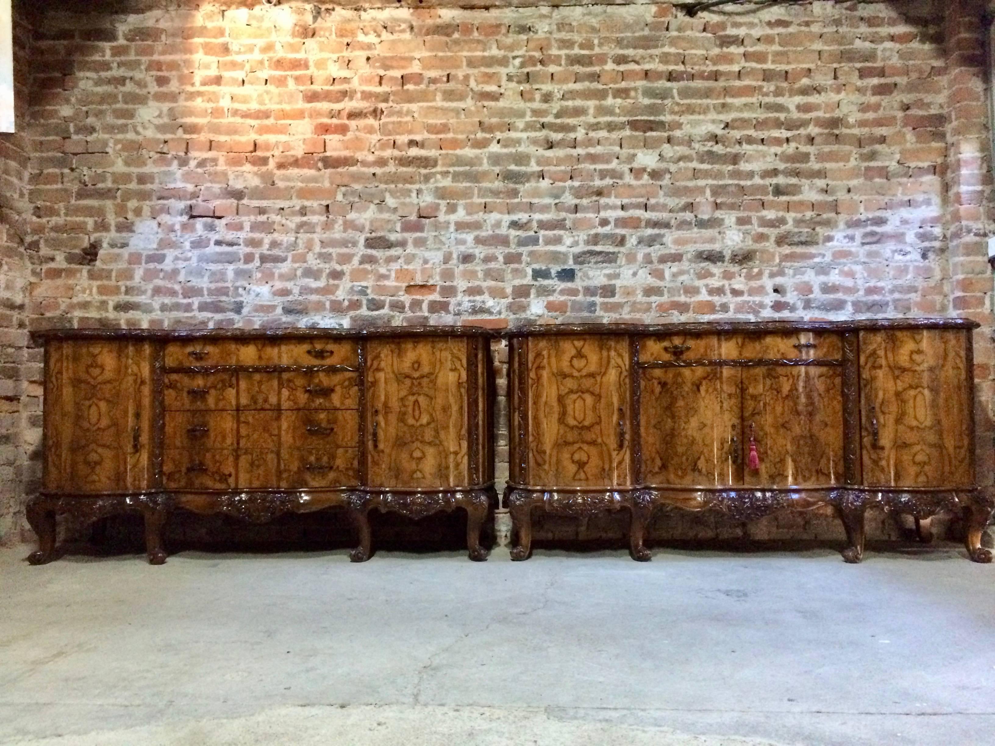 A beautiful 20th century antique style Italian burr walnut marble topped sideboard credenza, the large black inlaid marble top with moulded top and serpentine front over four central drawers flanked by two cupboards both with shelves within, please