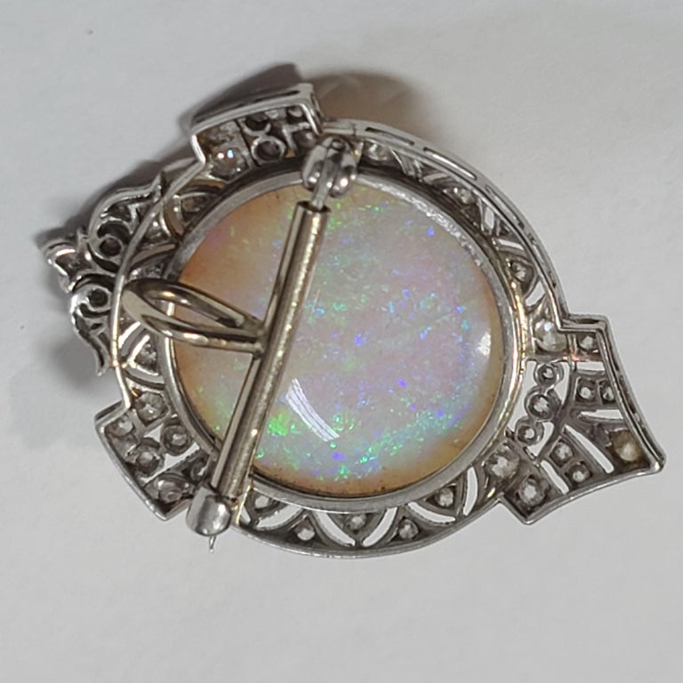 One of the largest and most magnificent natural Australian opal cabochons we have ever seen, set in an exquisite and signed Black Starr & Frost brooch set with diamonds that has been outfitted with a tube that can convert the brooch to a pendant.