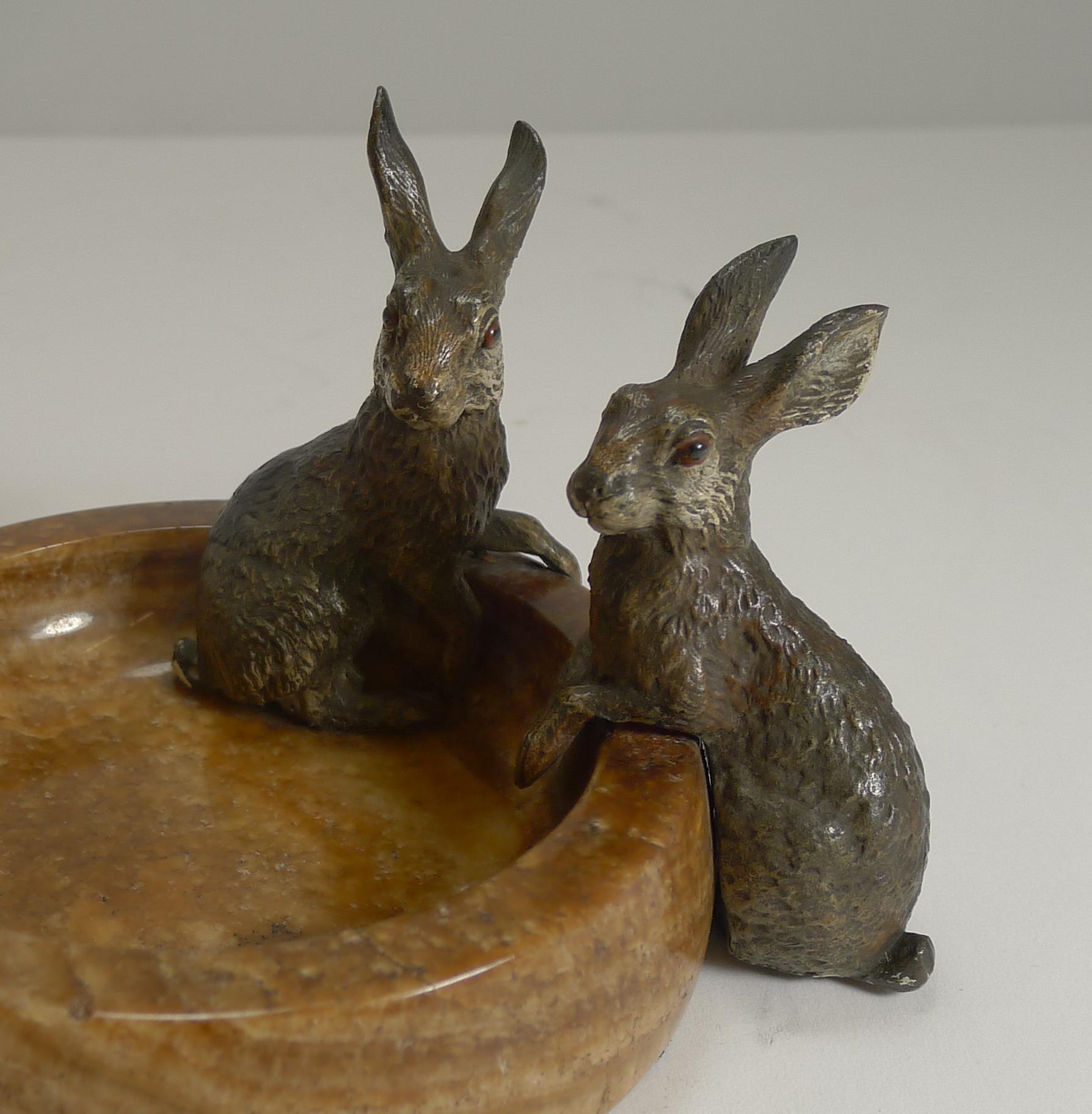 About as charming as they come, this is a rare example of it's kind with two very sweet Rabbits or Hares at the side of this polished stone dish.

One of the figures is sitting inside the dish and the other outside, both beautifully cast with