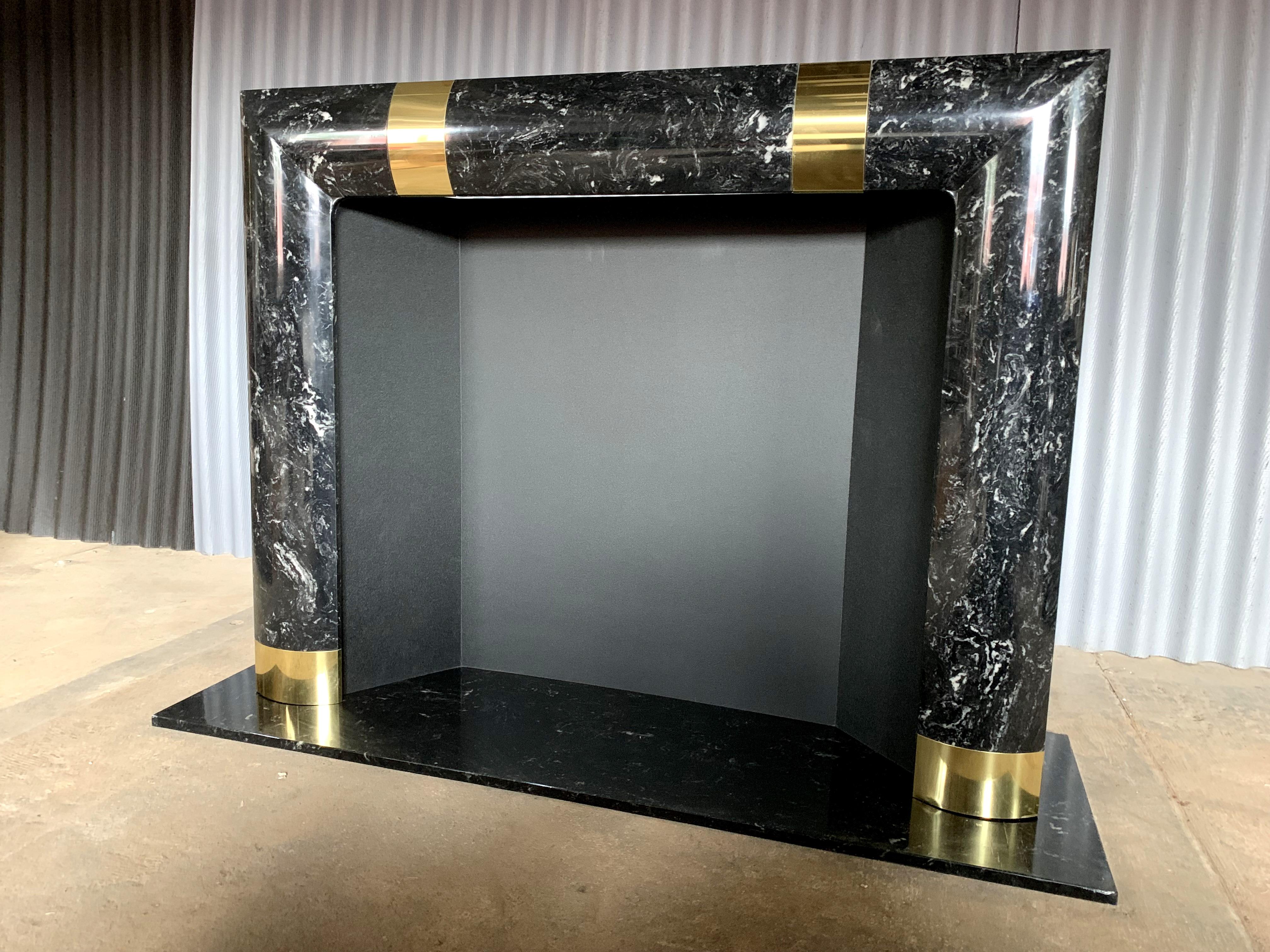 Beautiful and incredible fireplace surround with brass trimmings.
This fireplace surround sits on a marble platform.
Although quite heavy and substantial, I cannot confirm that it's real marble but a composite material. And once again, very heavy