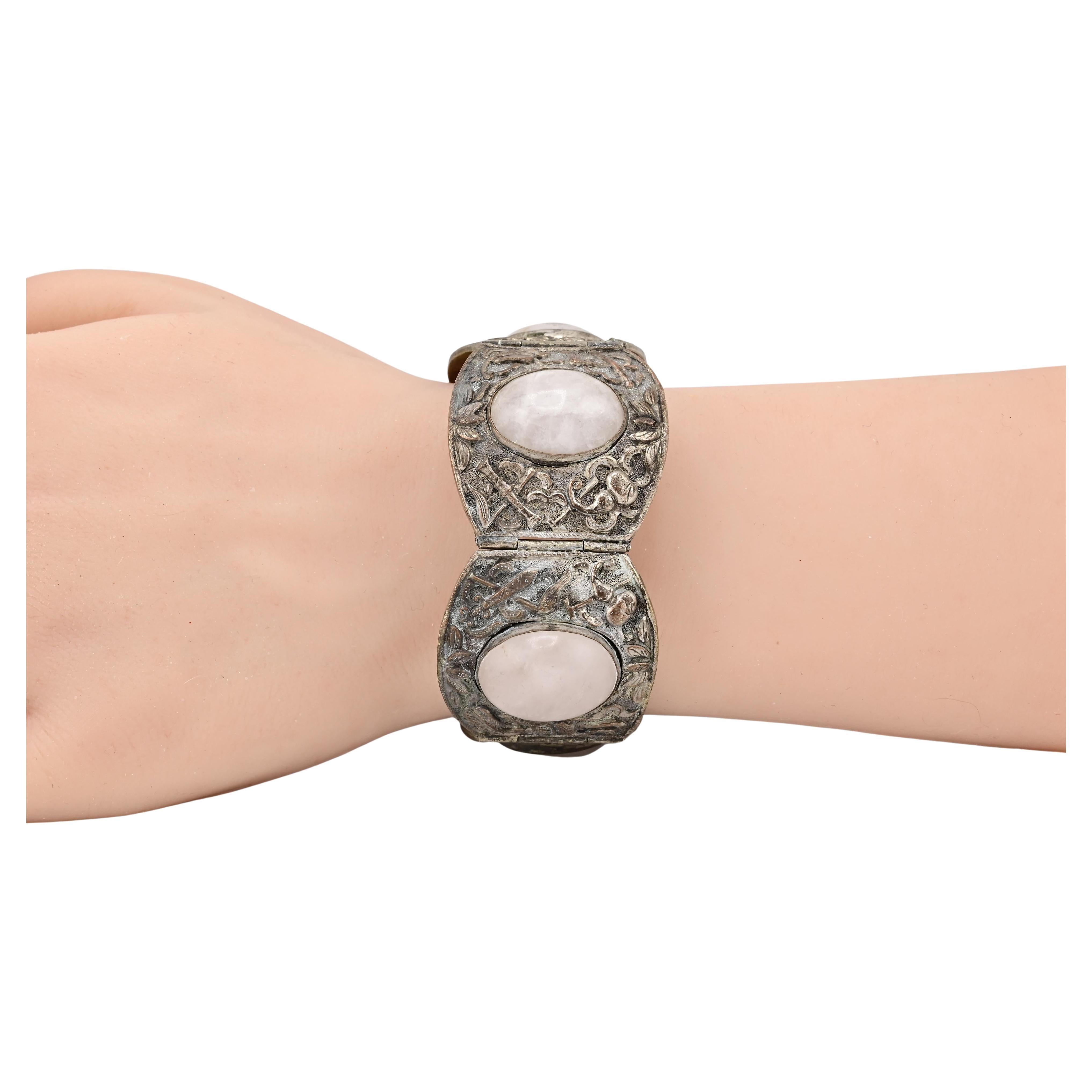This Exquisite Vintage Silver Bracelet is a captivating piece. Featuring intricate floral engravings and large oval quartz stones, it exudes elegance and charm. The bracelet's design showcases detailed craftsmanship, with each segment connected