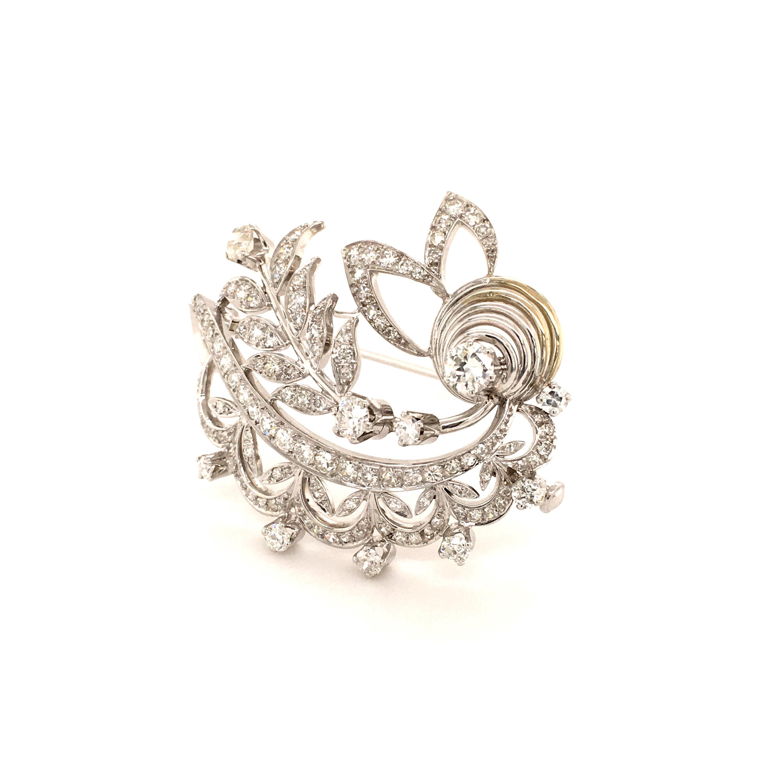 This beautifully handcrafted floral brooch in 18 karat white gold is set with 10 old cut diamonds of G/H color and vs/si clarity. The smaller 108 diamonds are either single cuts or old cuts of G/H color and vs/si clarity, total weight approximately
