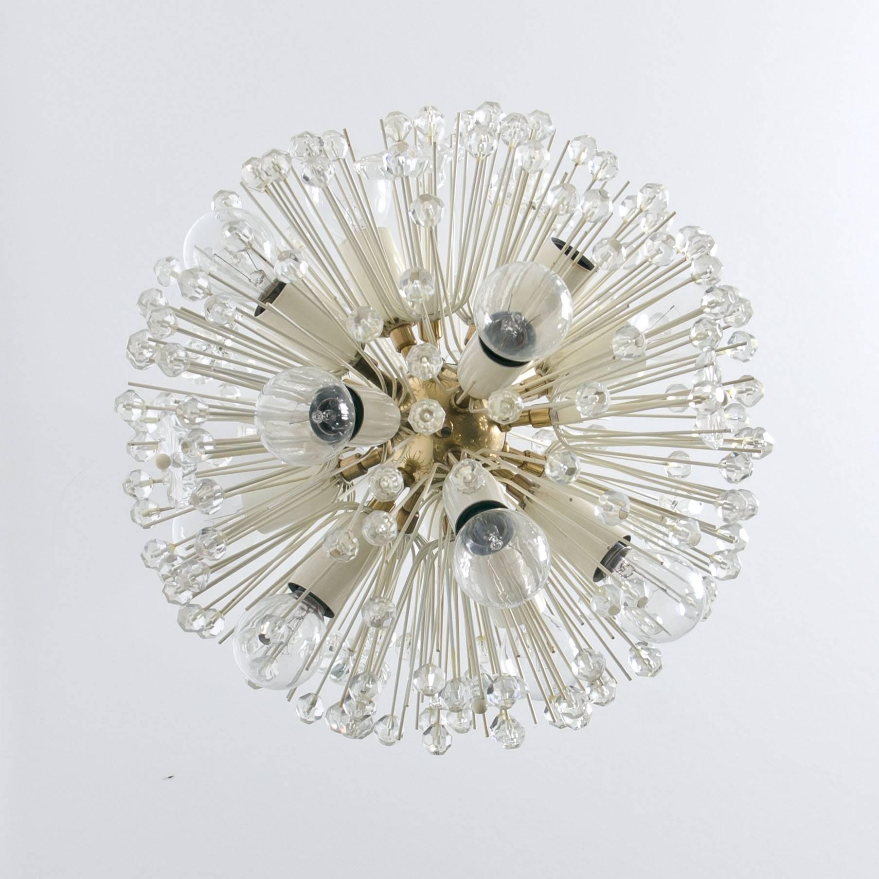 Sputnik nine-light brass fixture with copious amounts of Austrian crystals by Emil Stejnar for Nikoll. Cosmological. This glamorous delicate brass ‘Snowball’ Sputnik chandelier is also known as ‘pusteblume’, or ‘snowflake’ and is made in Vienna
