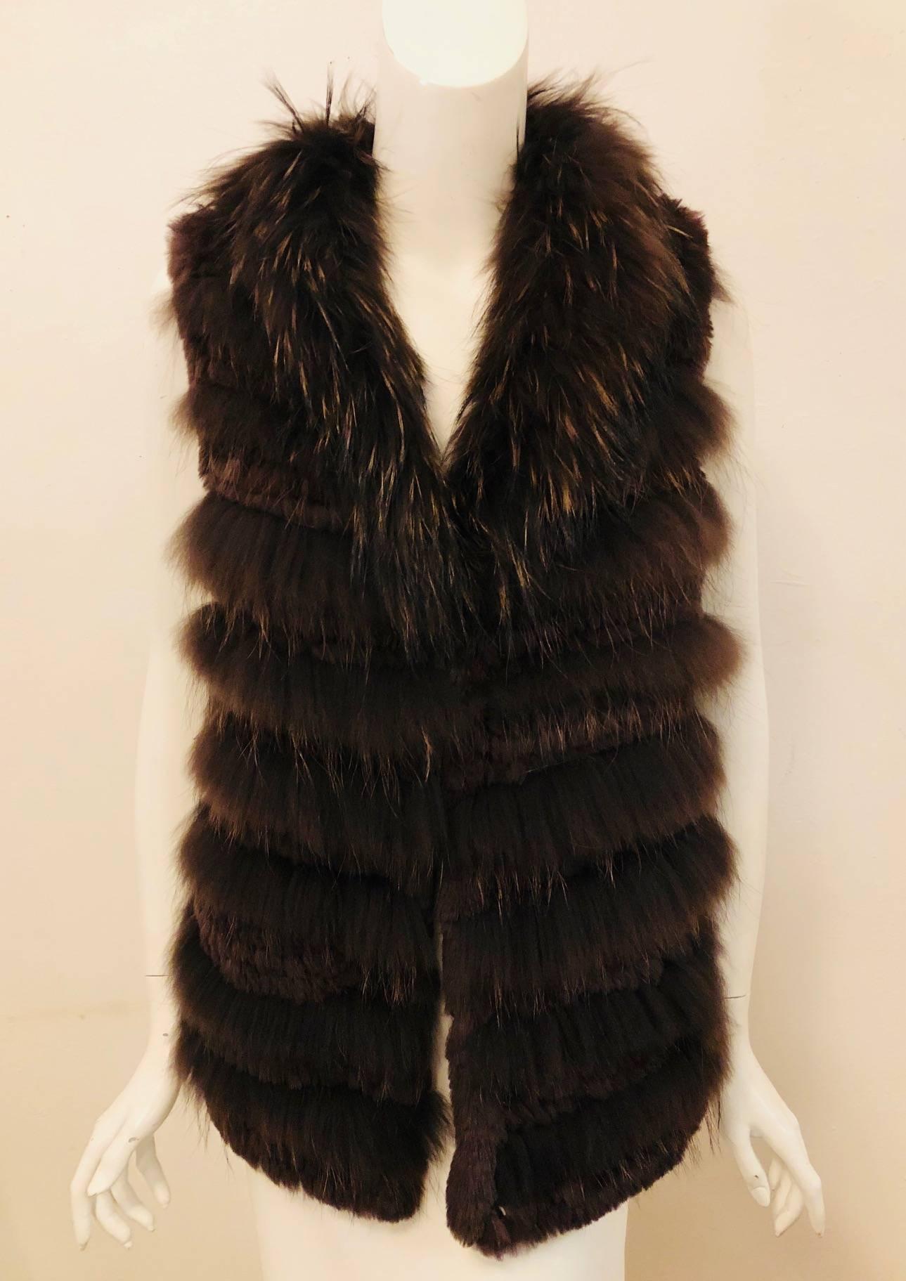 Fabiana Filippi  brown fox fur knitted vest is comfortable as well as fashionable.  The symmetrically placed horizontal fox strips are knitted together with longer pieces of fur trimming the vest around the neckline to create the shawl collar.  For