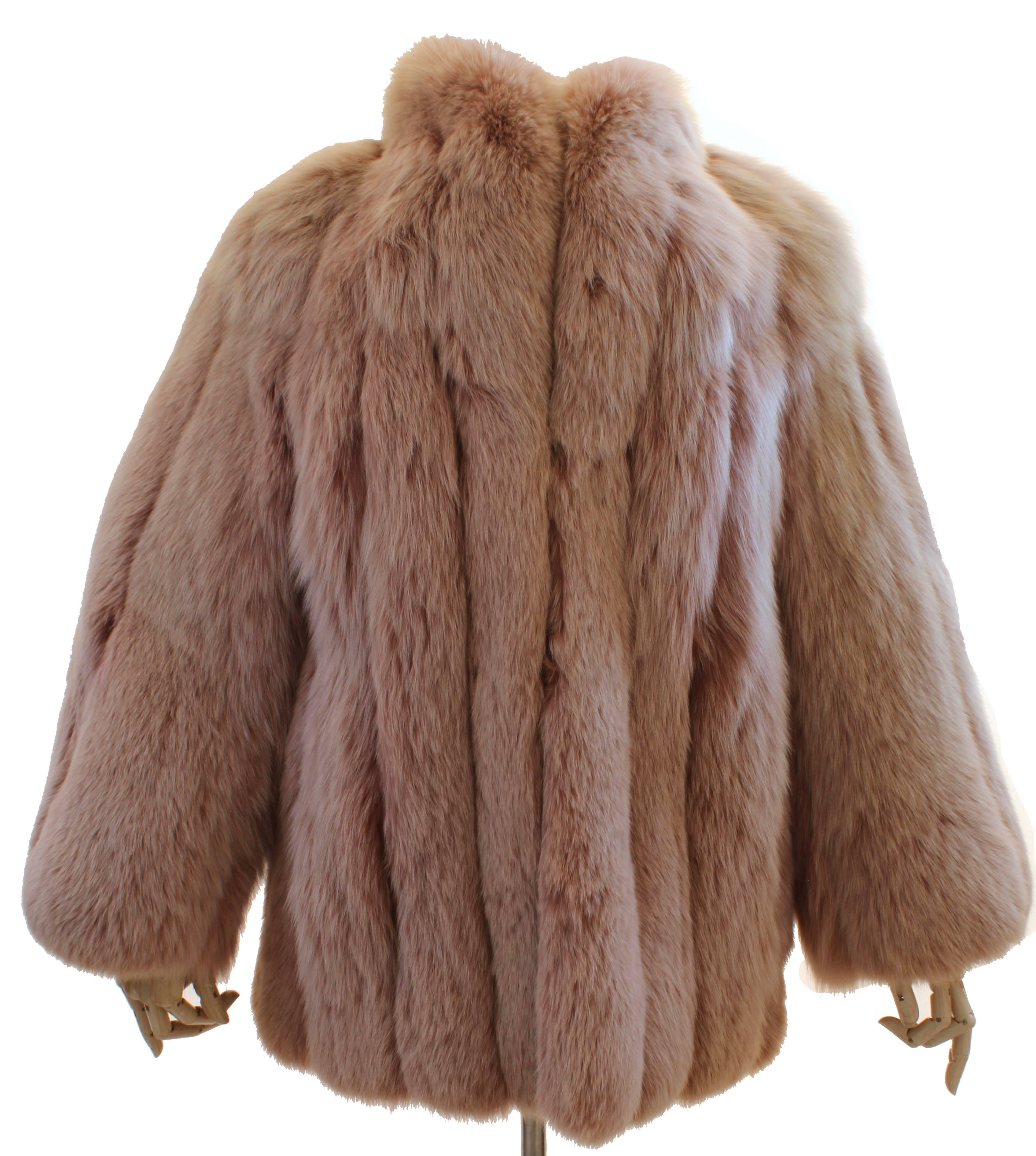 This fabulous fox fur coat is from Flah & Co Department Store, likely made in the 1970s.  Made from Fox fur, this piece has subtle tones of tan, pink and white throughout, giving it a chic look! In excellent condition for its age, the pelts are soft