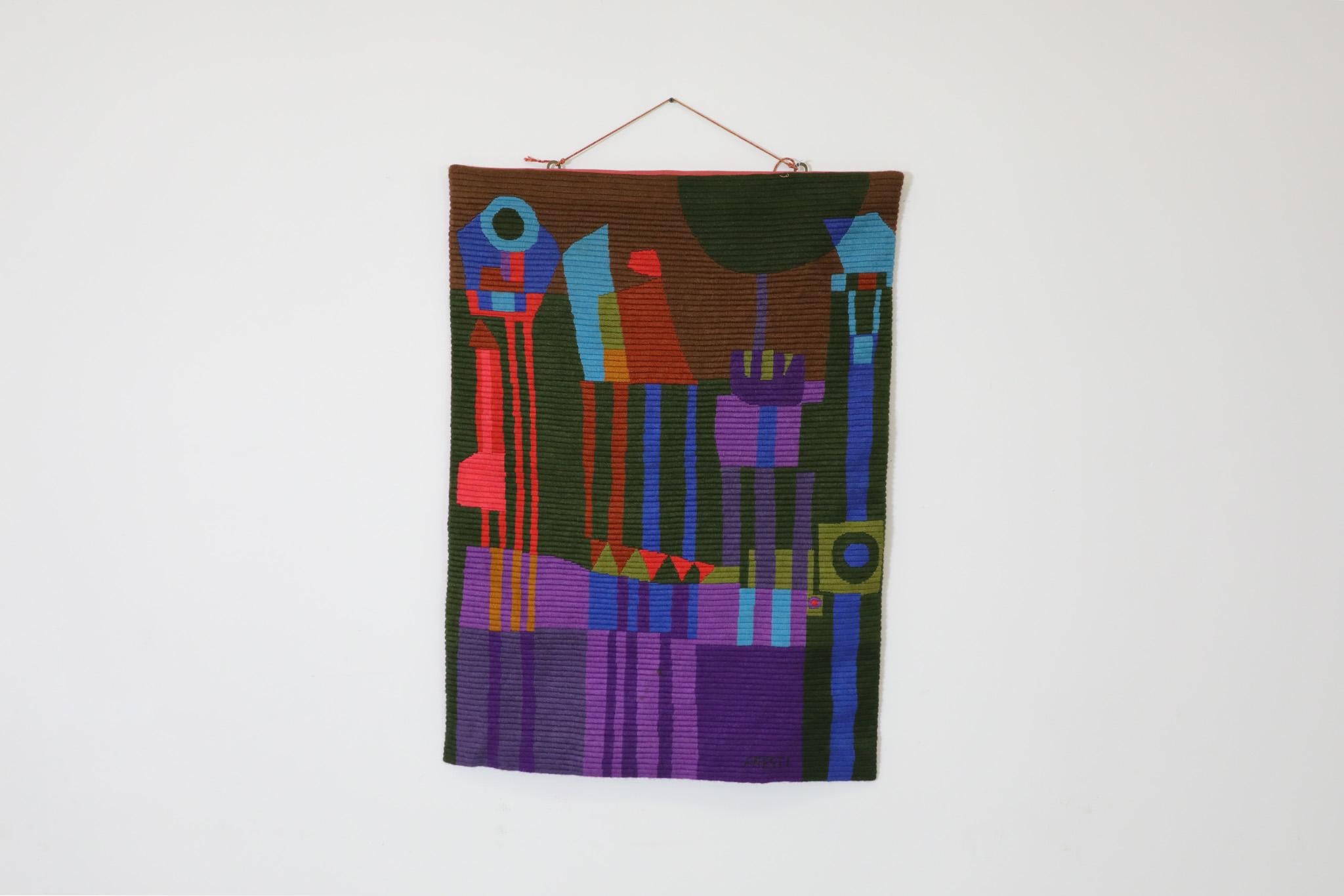 Mid-Century, Aresti, hand dyed woven fiber art tapestry. This abstract colorful textile art is made of thick knit cotton and has hanging string attached to the top. 