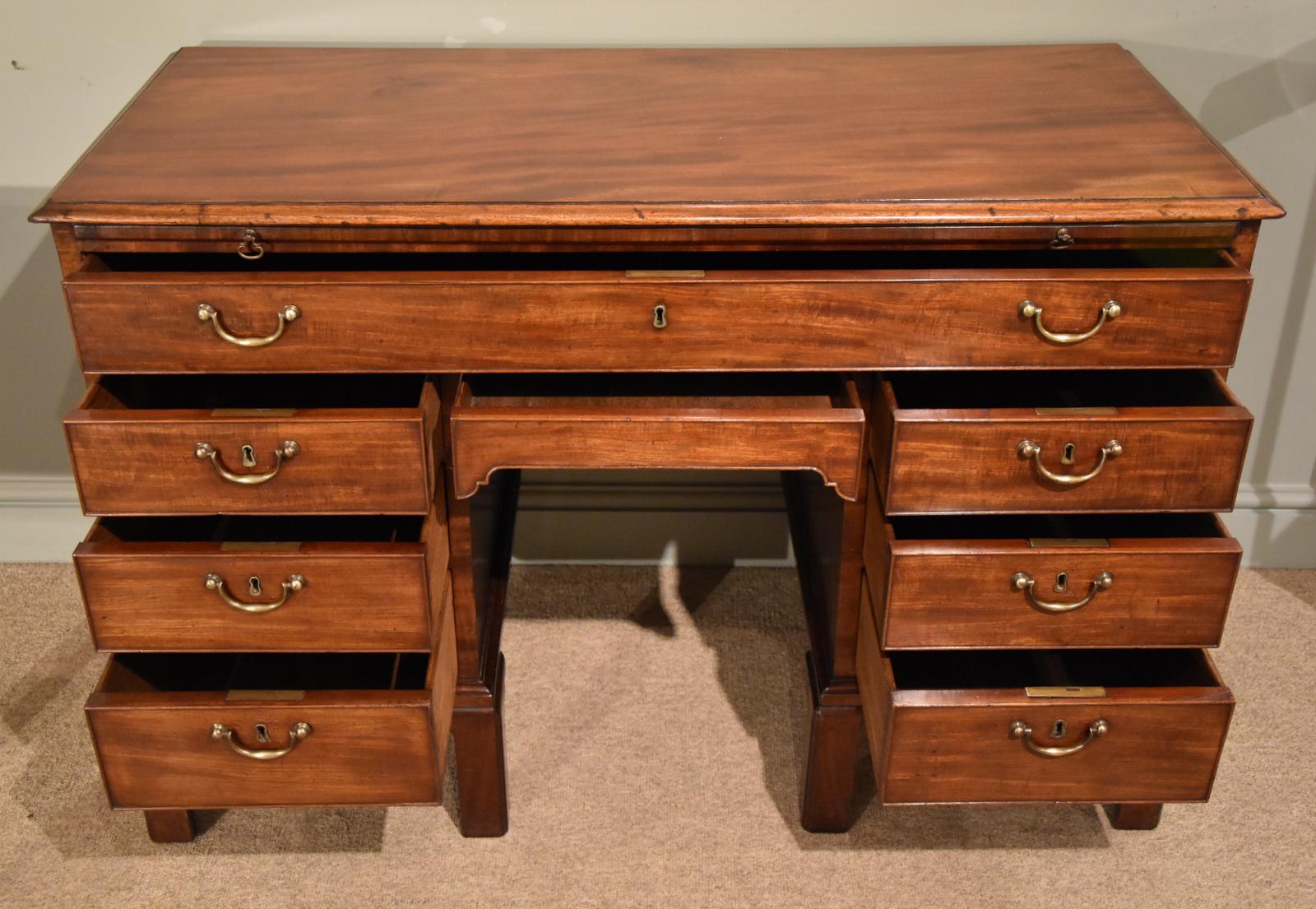 A fabulous George III mahogany kneehole desk with slide original handles and unusual Chinese Chippendale legs

Dimensions
Height 31.5