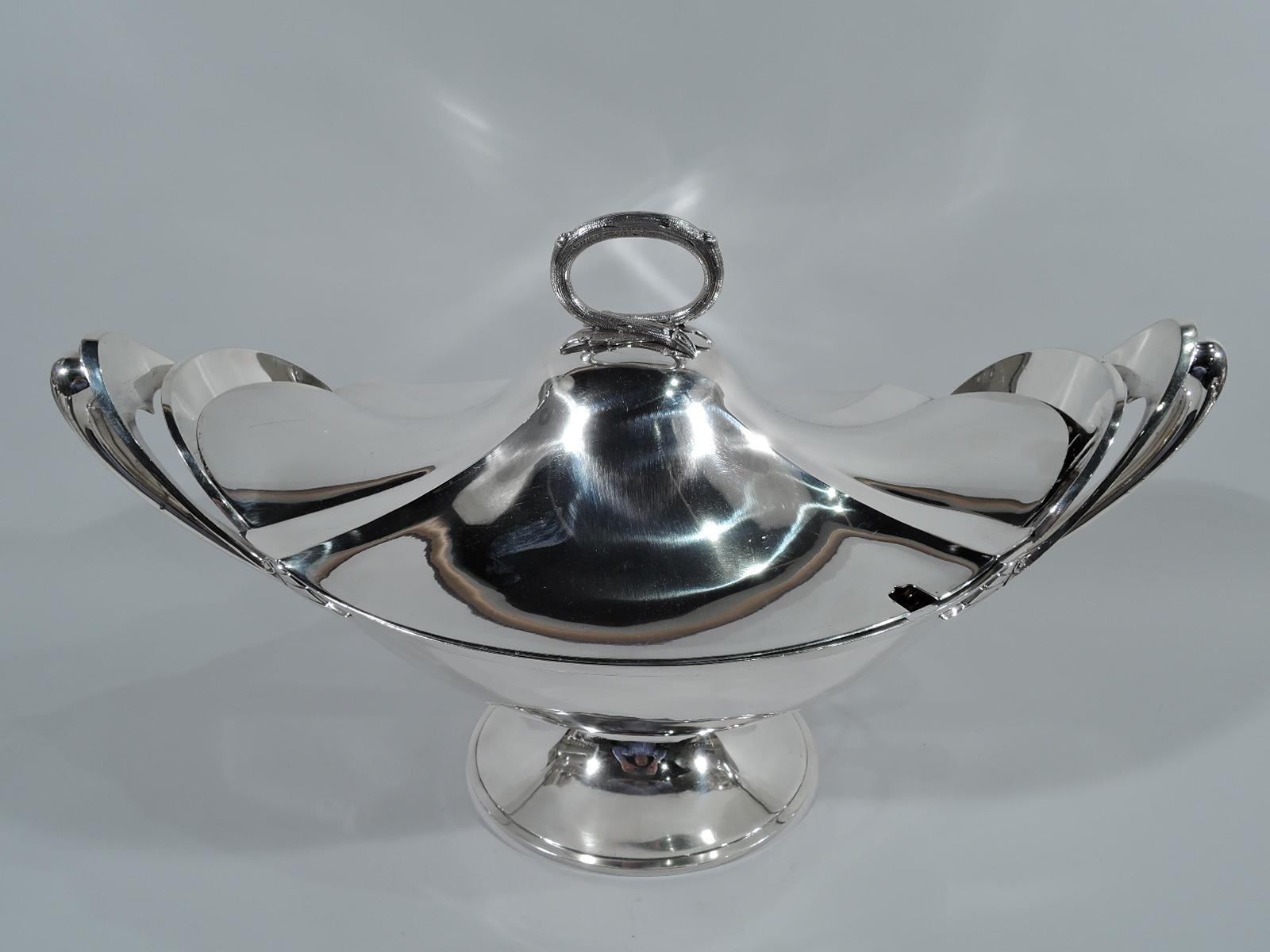 Fabulous aesthetic coin silver soup tureen. Made by Gorham in Providence, circa 1865. Ovoid bowl with shaped ends and molded rim on raised oval foot. Tapering scroll handle mounted at top to shaped and upside-down V terminating in stylized leaf