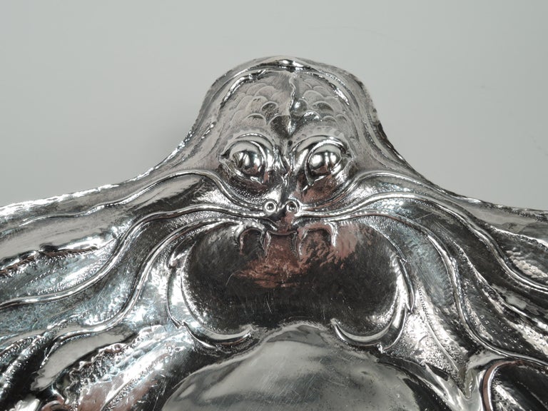 Fabulous Art Nouveau Martelé silver fish platter. Made by Gorham in Providence on April 6, 1898. Shaped and narrow oval well. Tapering and chased shoulder. At ends are scaly fish heads with exophthalmic eyes and tentacular whiskers. On sides more