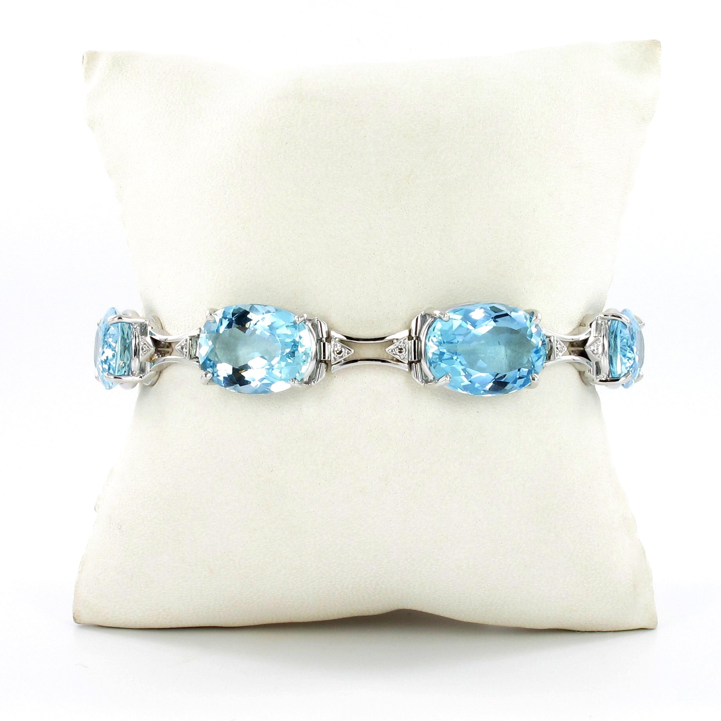 This timelessly elegant bracelet by reknown jeweller H. Stern features seven oval shaped aquamarines of high claritiy and vibrant luster. Their total weight is approximately 46.80 carats. Each aquamarine is accented by two single cut diamonds of G/H
