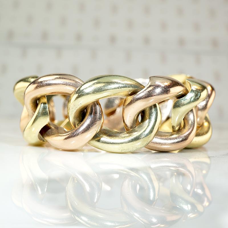 This Retro two-tone curb chain bracelet is gorgeous, bold, and stunning. Fat, curvy links in glowing 14k yellow and rose gold alternate in color. The closed-back links are smooth and comfortable to wear, so supple with a luxurious size and weight.