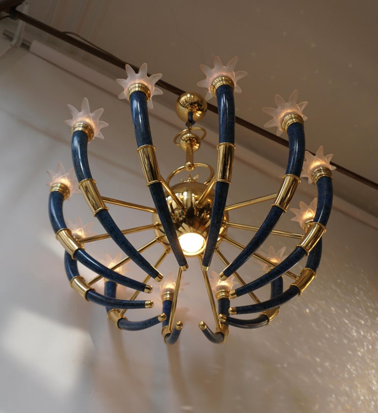 Spectacular Italian blue torch horn chandelier in Murano glass and brass with eagle.

The light requires 12 single E14 screw fit lightbulbs (60Watt max.) LED compatible.
Measures:
Diameter 32.28 inch, 82 cm 
Height fixture 33.07 inch, 84 cm 
Total