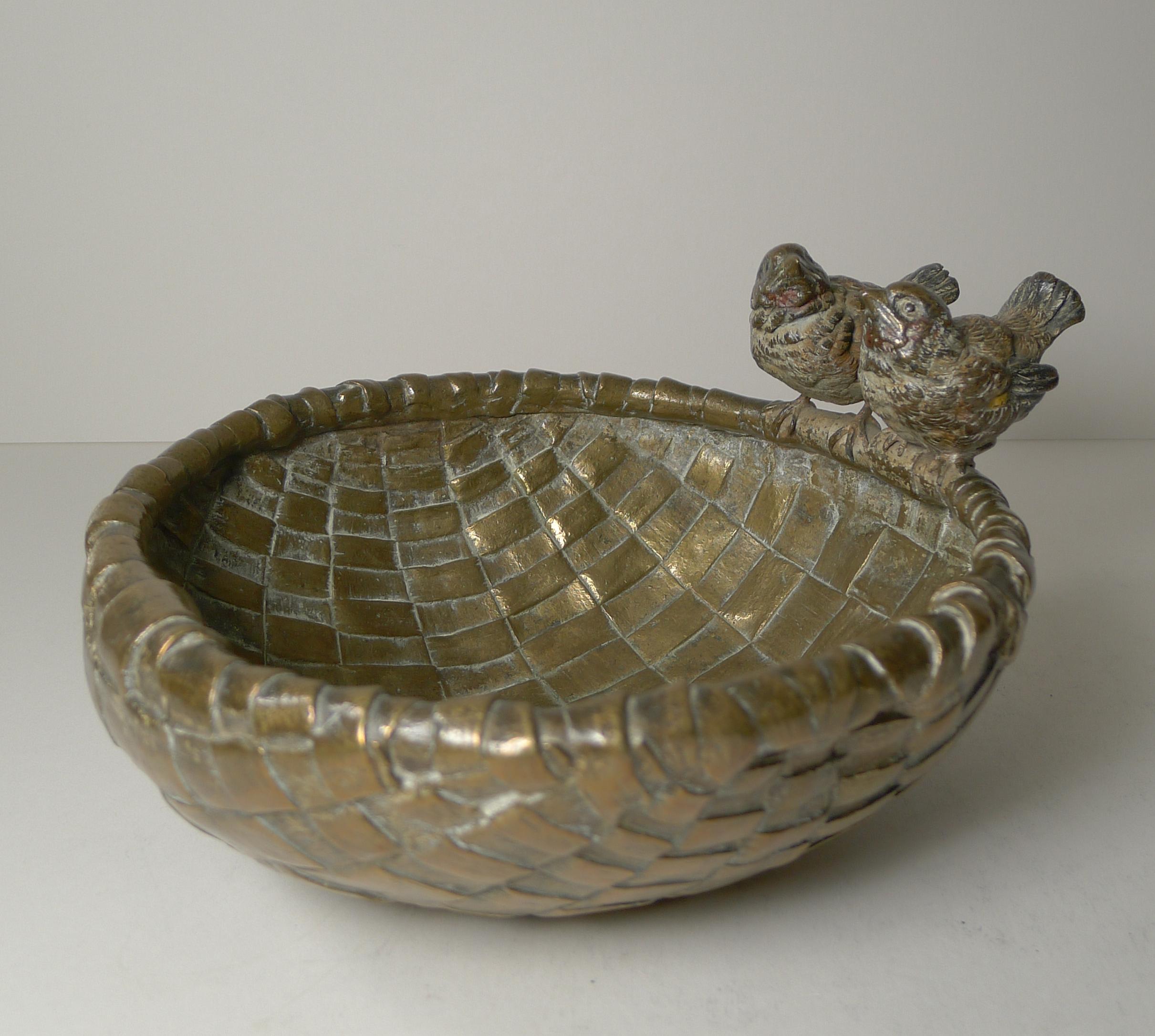 A fabulous impressive large bronze, a very solid and heavy piece. The bowl is fashioned to resemble a basket with some cold painted highlights in places.

On the side are the two most adorable cold painted birds (Wrens), beautifully cast and with