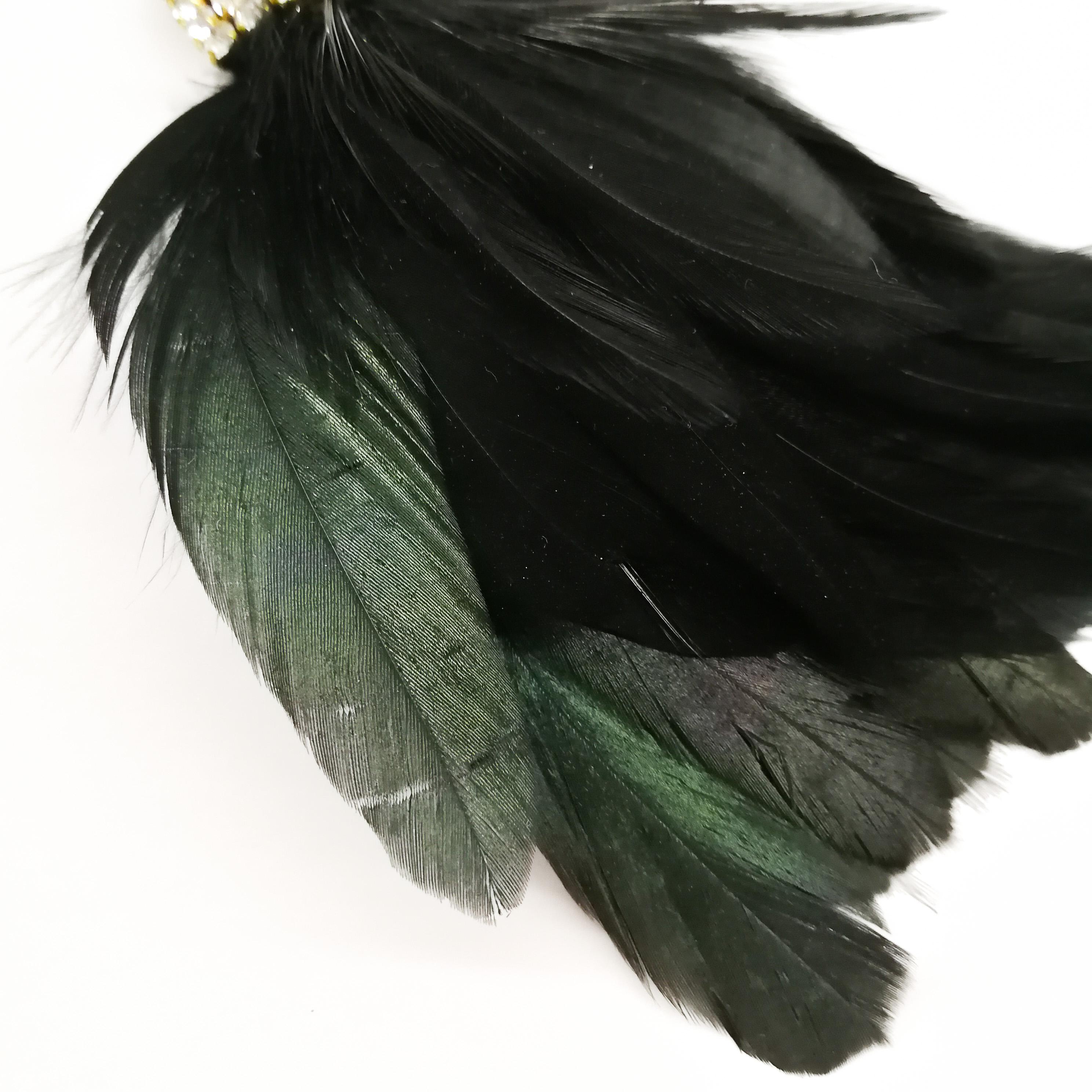 Magnificent and opulent large 'Bird Of Paradise' or 'Toucan' earrings by Isabel Canovas, made from gilded metal and lush feathers, with clear and sapphire paste highlights. The earrings have a clip on fitting, and hang down , with the bird's head on