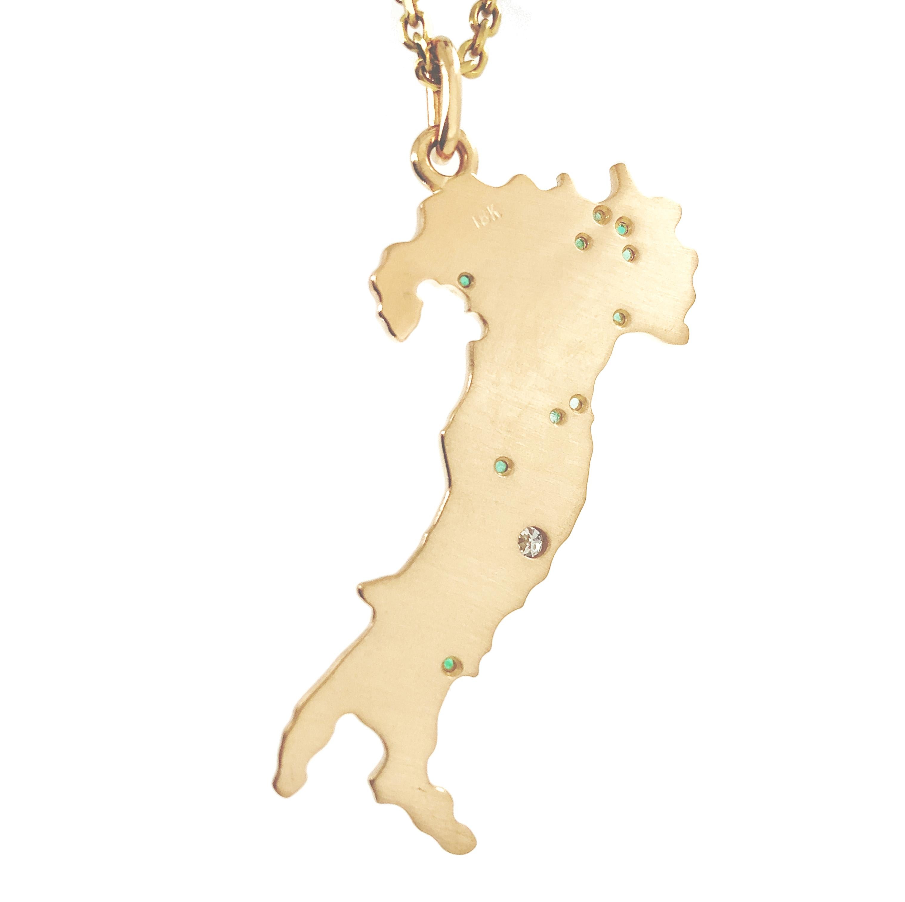 Figural map of Italy pendant/charm.  Capitol city of Rome is set with a faceted bezel-set diamond.  Other major cities are named and set with faceted emeralds.  Solid gauge 18K yellow gold.  1