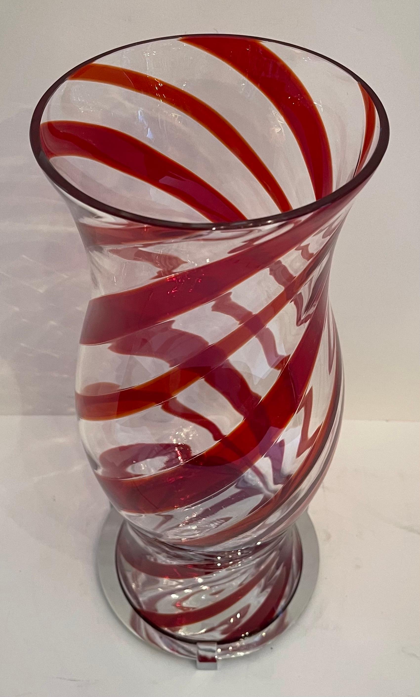 A fabulous modern Italian Murano hurricane hand blown urn-shaped glass shade with a red swirl motif resting on a polished nickel base (base measures 7 1/4