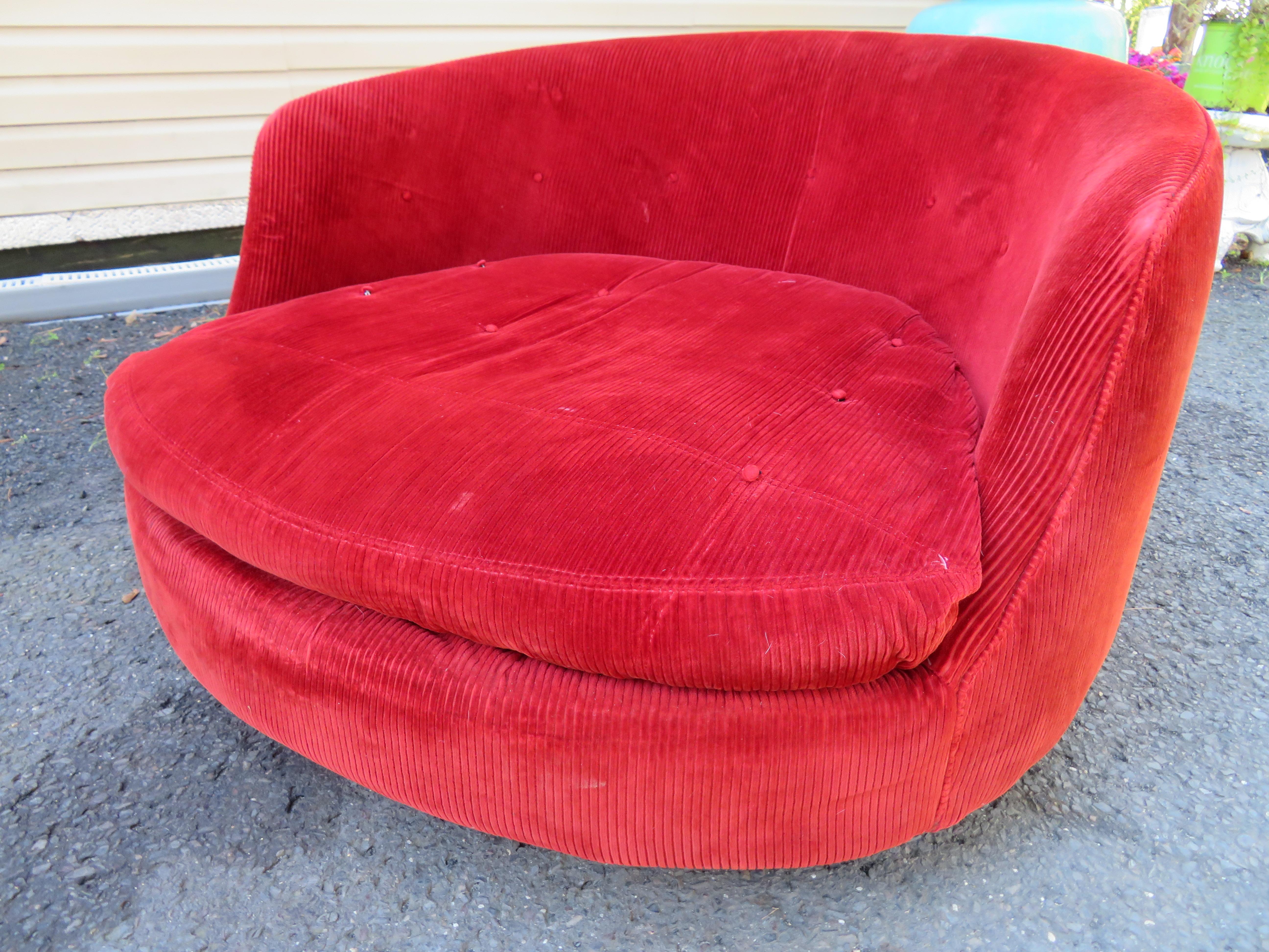 Gorgeous Milo Baughman for Thayer Coggin oversized circular swivel lounge chair. This piece retains its original cranberry corduroy fabric in usable condition, some buttons missing-reupholstery is recommended. You will love the style and comfort of