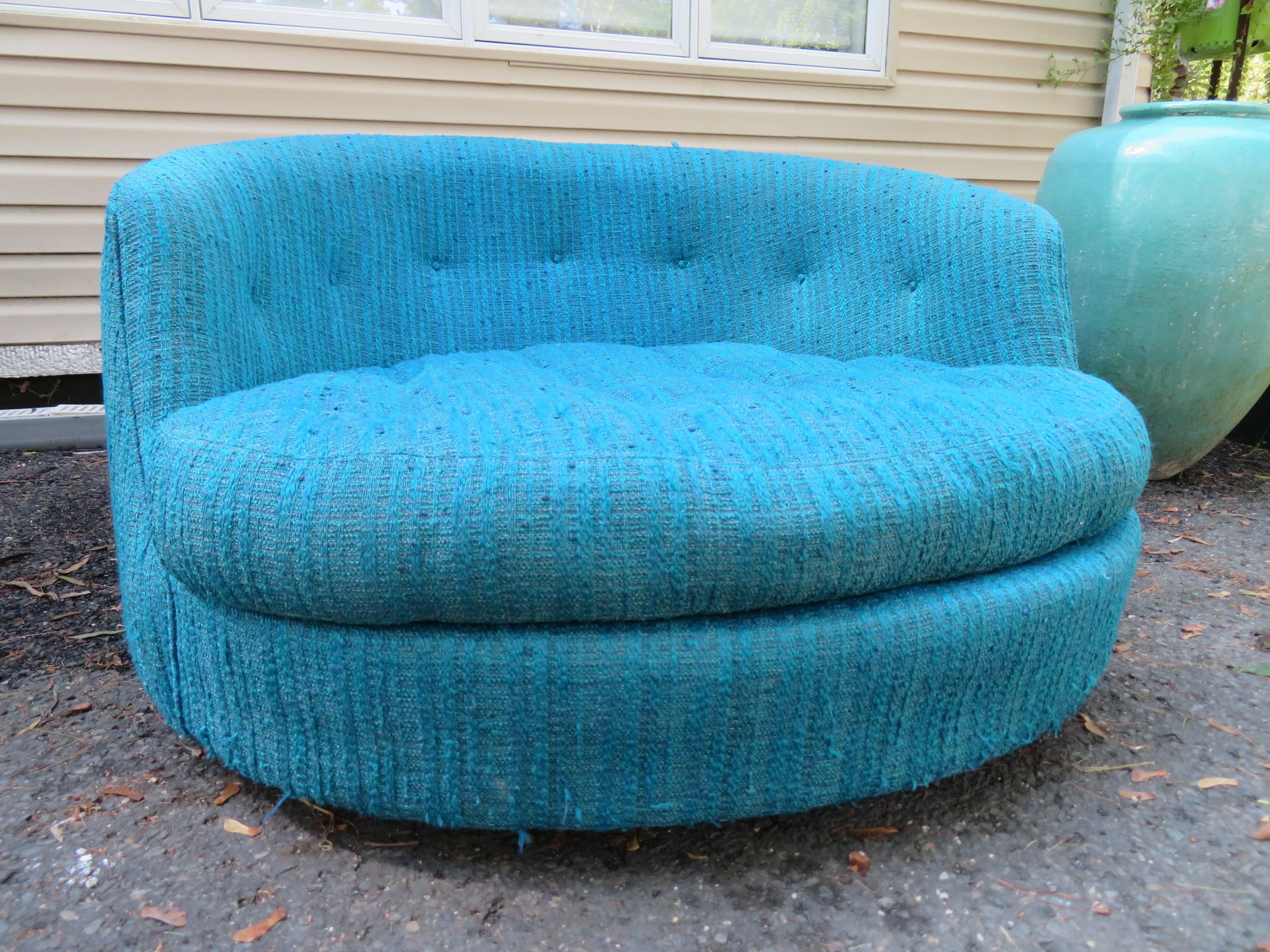 Gorgeous Milo Baughman for Thayer Coggin oversized circular swivel lounge chair. This piece retains its original turquoise blue wool woven fabric in usable condition, some pulls and loose strings-reupholstery is recommended. You will love the style