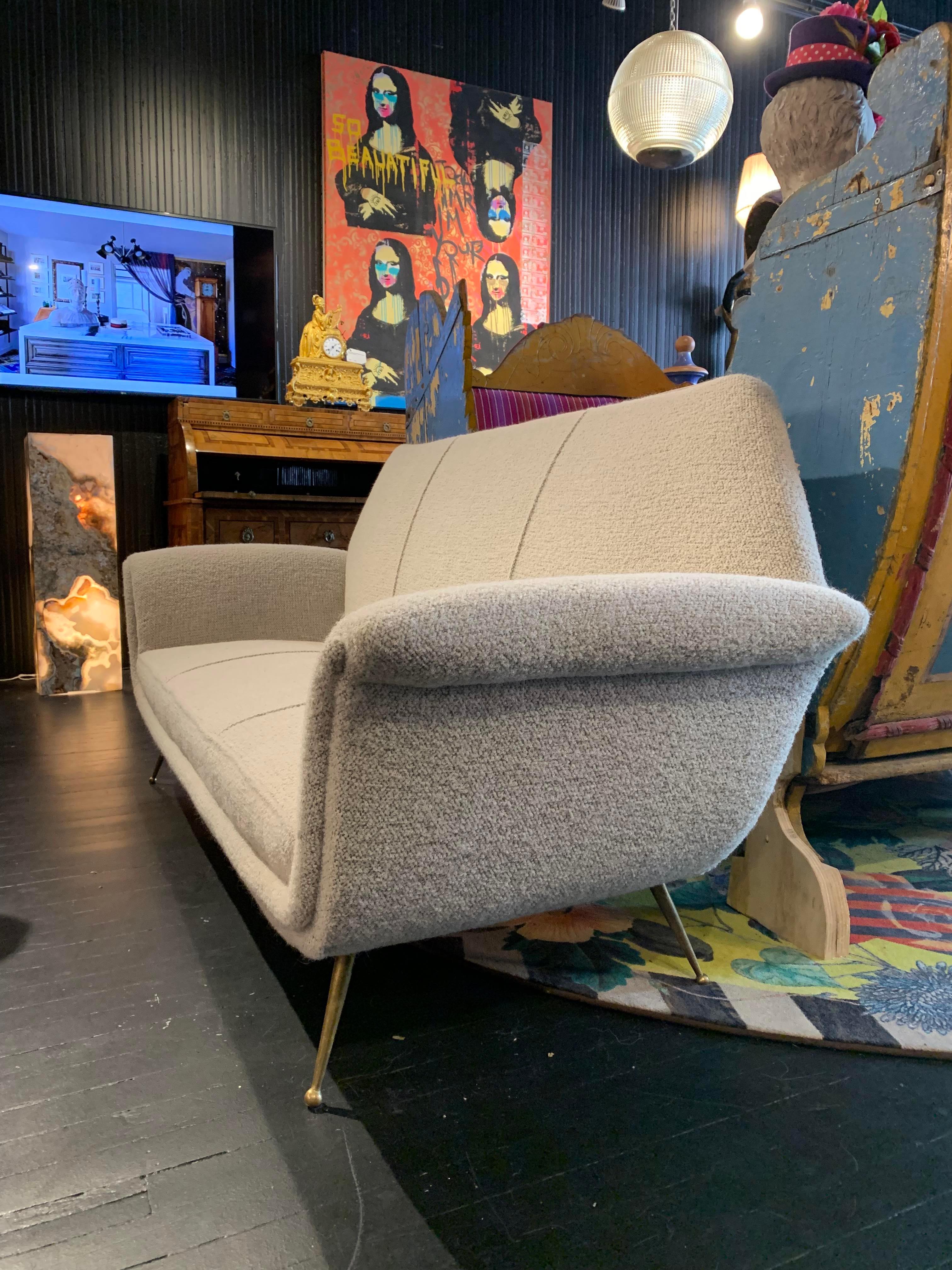 Very special shape on this stunning mid century settee. Stunning boucle Pierre Frey fabric. Cool mid century legs. In near pristine condition.