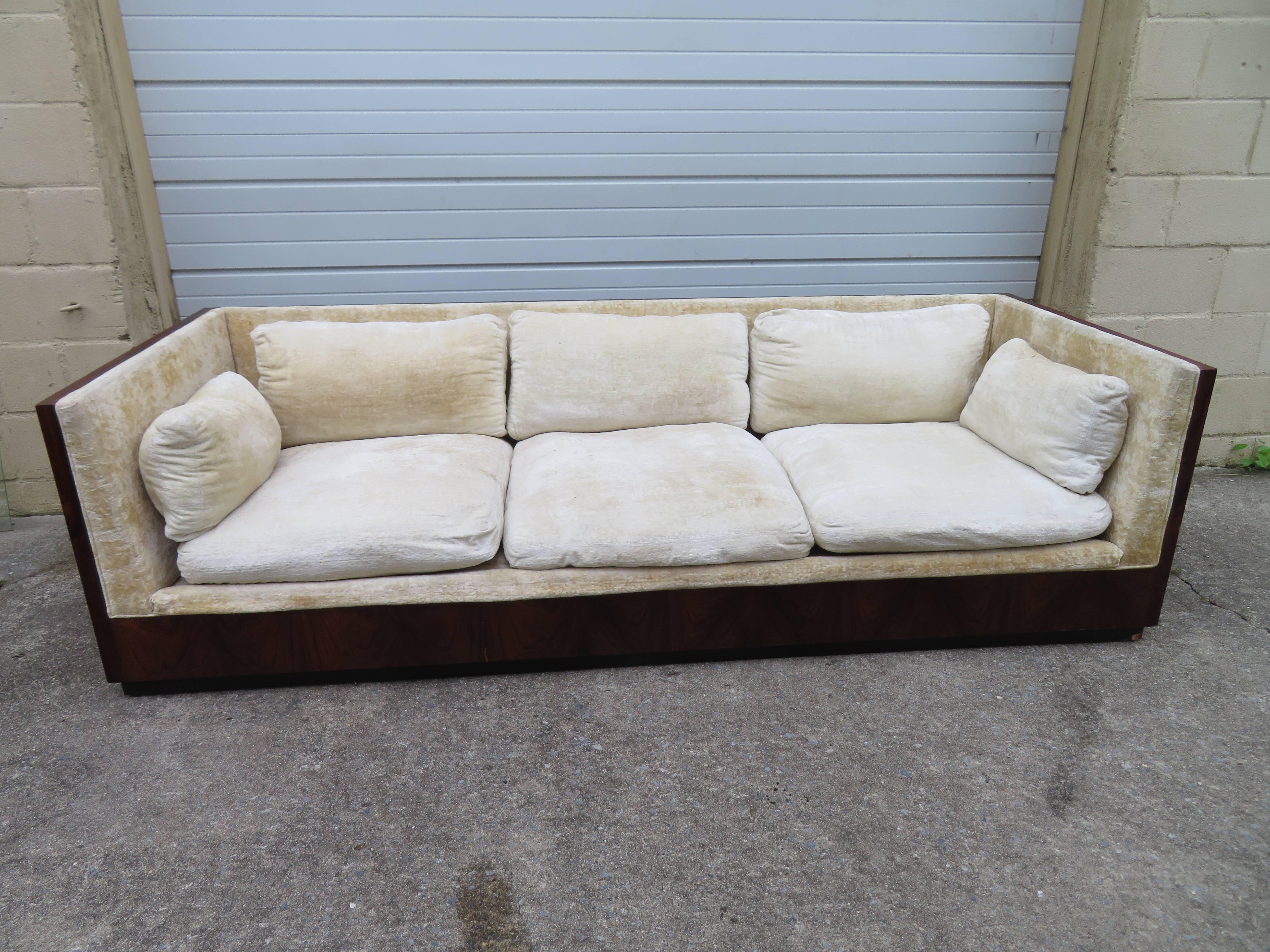 Simply gorgeous Milo Baughman rosewood case sofa. The back is stunning with nicely figured rosewood veneer. This piece will need to be reupholstered but that's what you designers are looking for anyway-right? The rosewood case is in fantastic