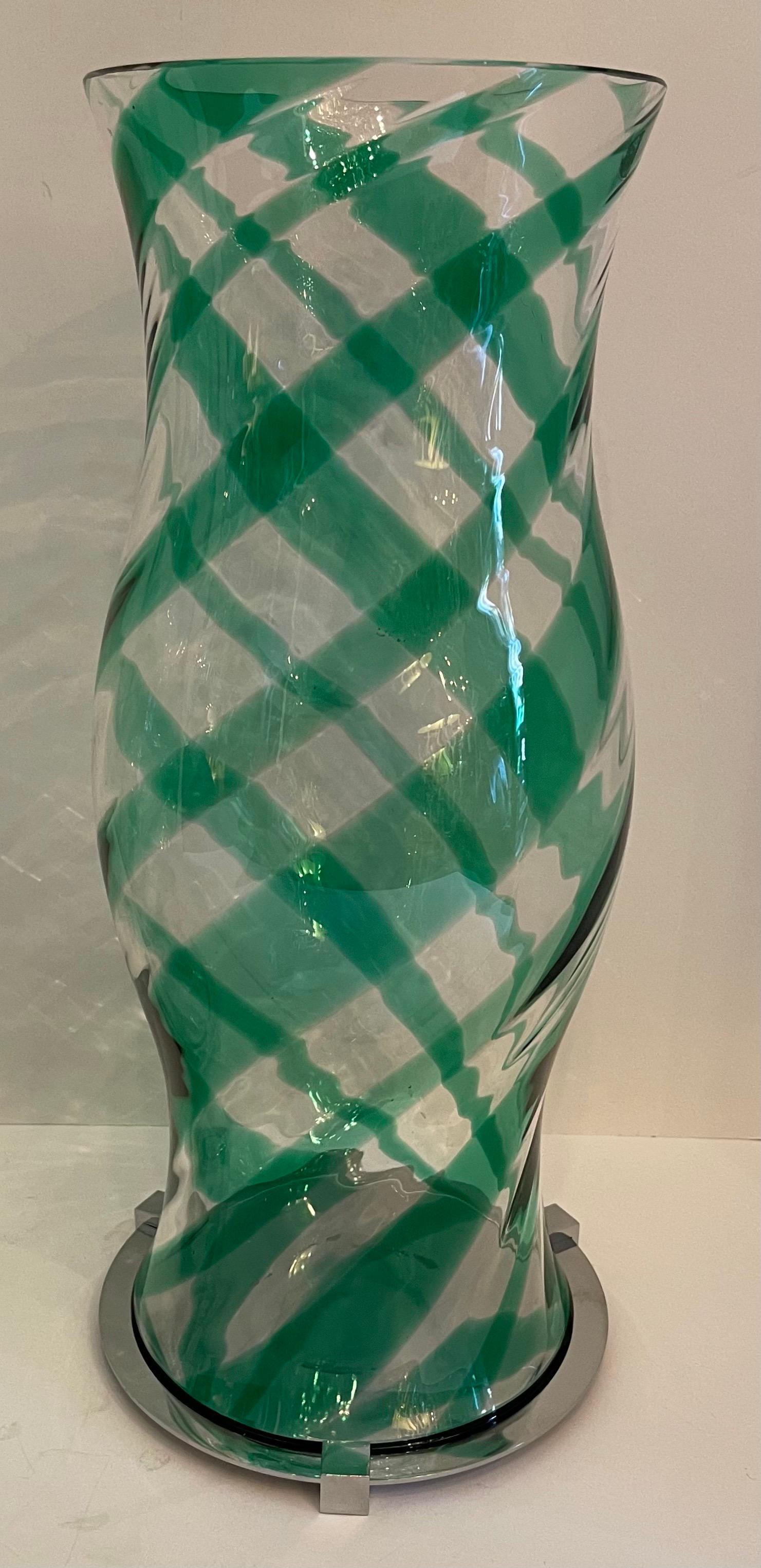 A fabulous pair of modern Italian Murano hurricane hand blown urn-shaped glass shades with a green swirl motif resting on polished nickel bases (base 7 1/4