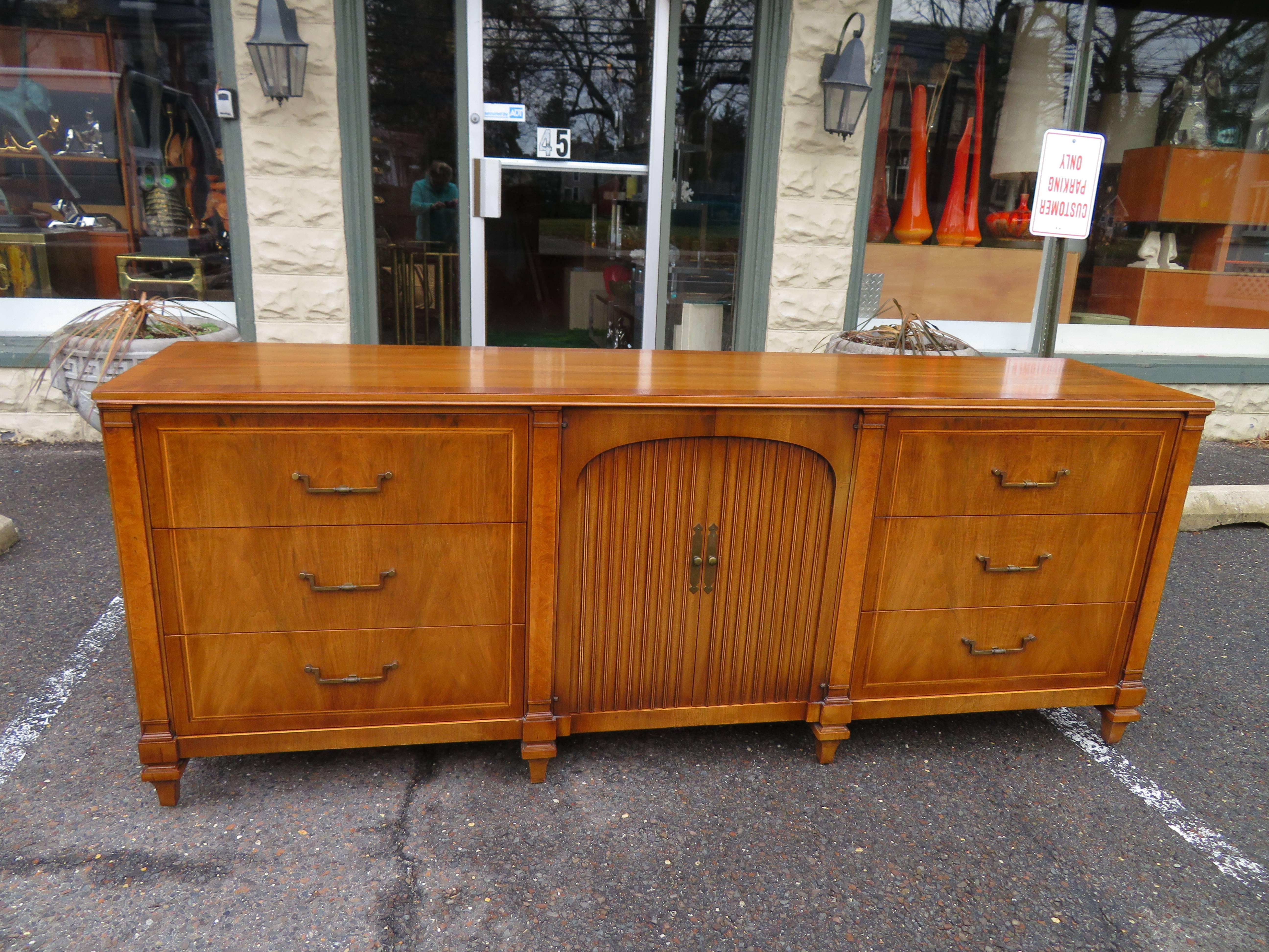Fabulous neoclassical designed walnut credenza by Widdicomb. Just take a look at all the wonderful details and craftsmanship of this magnificent piece. They surely don't make furniture like this anymore that's for sure.