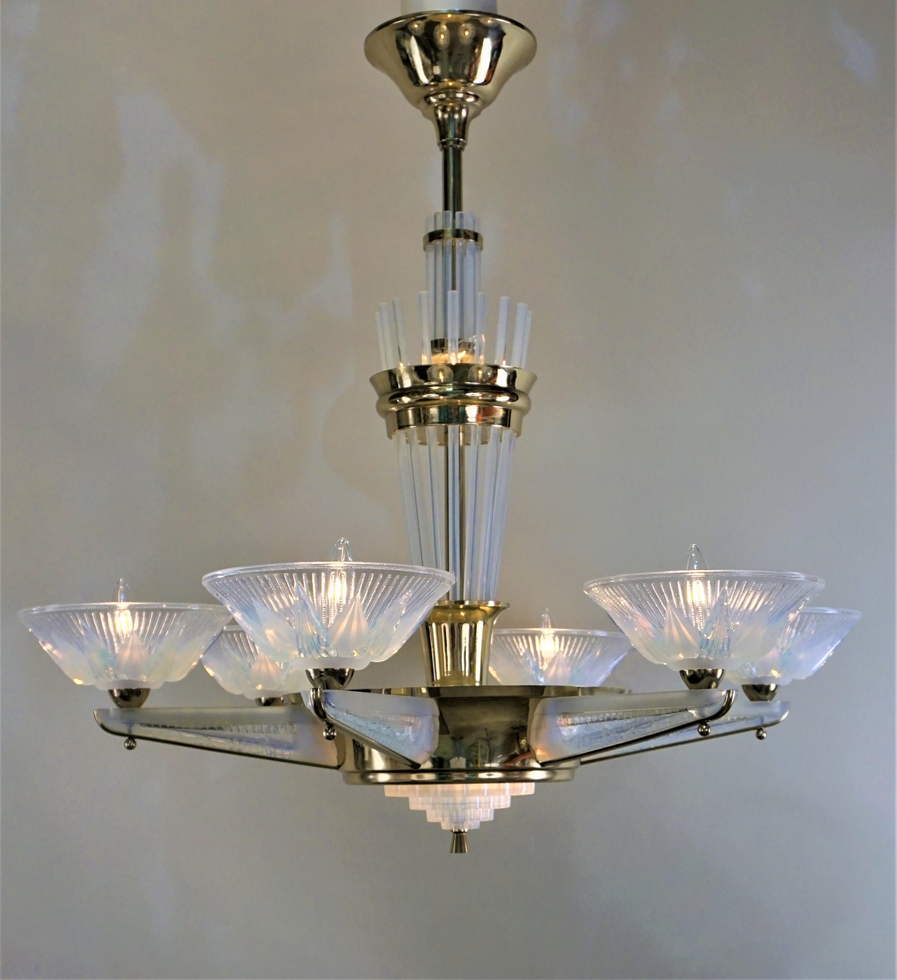 A stunning French polished bronze Art Deco six-arm chandeliers with opalescent glass arms and shades even the centre column adorned with opalescent glass. These chandelier has total of nine lights.