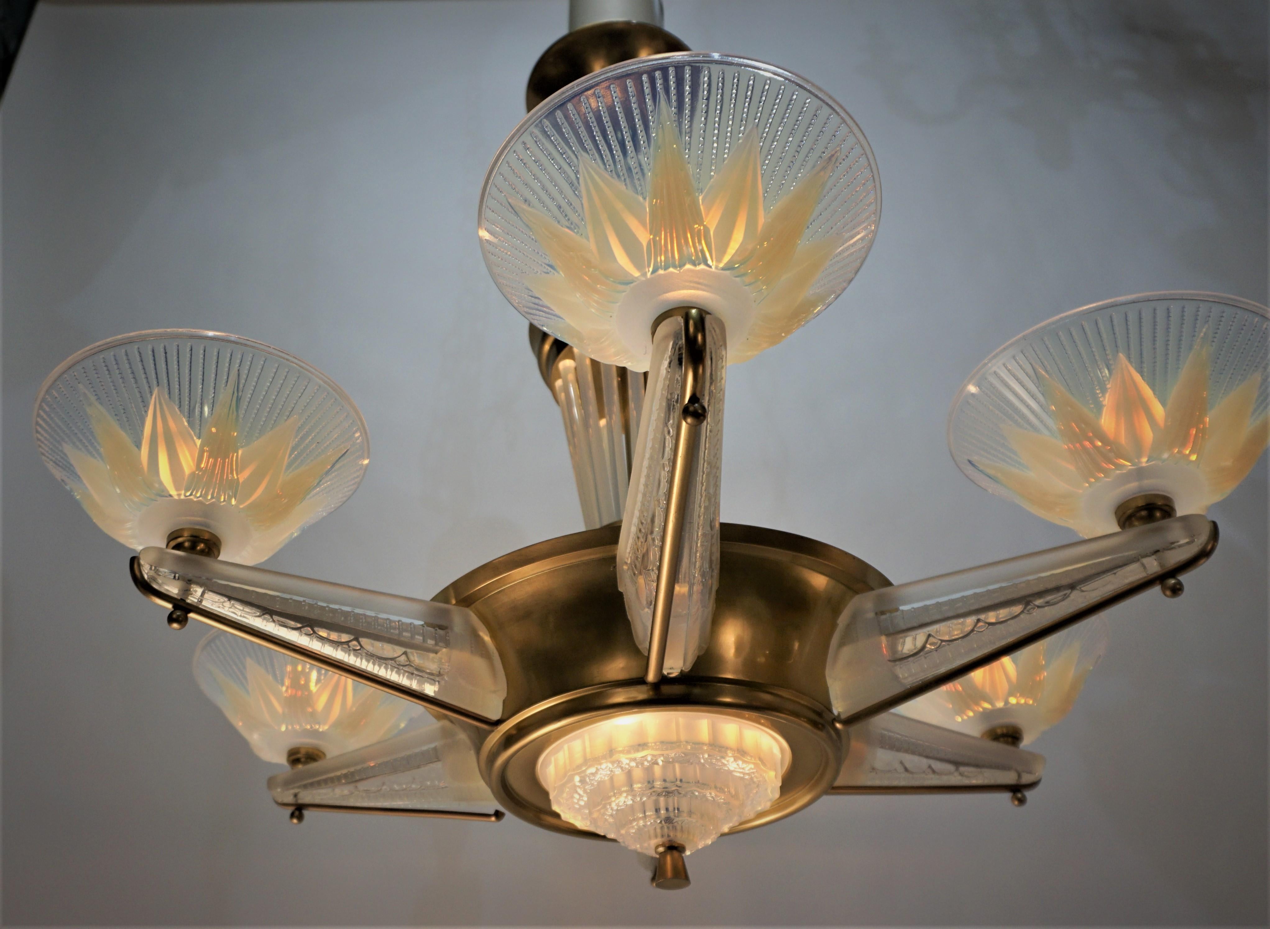 A stunning French polished bronze Art Deco six-arm chandeliers with opalescent glass arms and shades even the center column adorned with opalescent glass. This chandelier has total of nine lights.